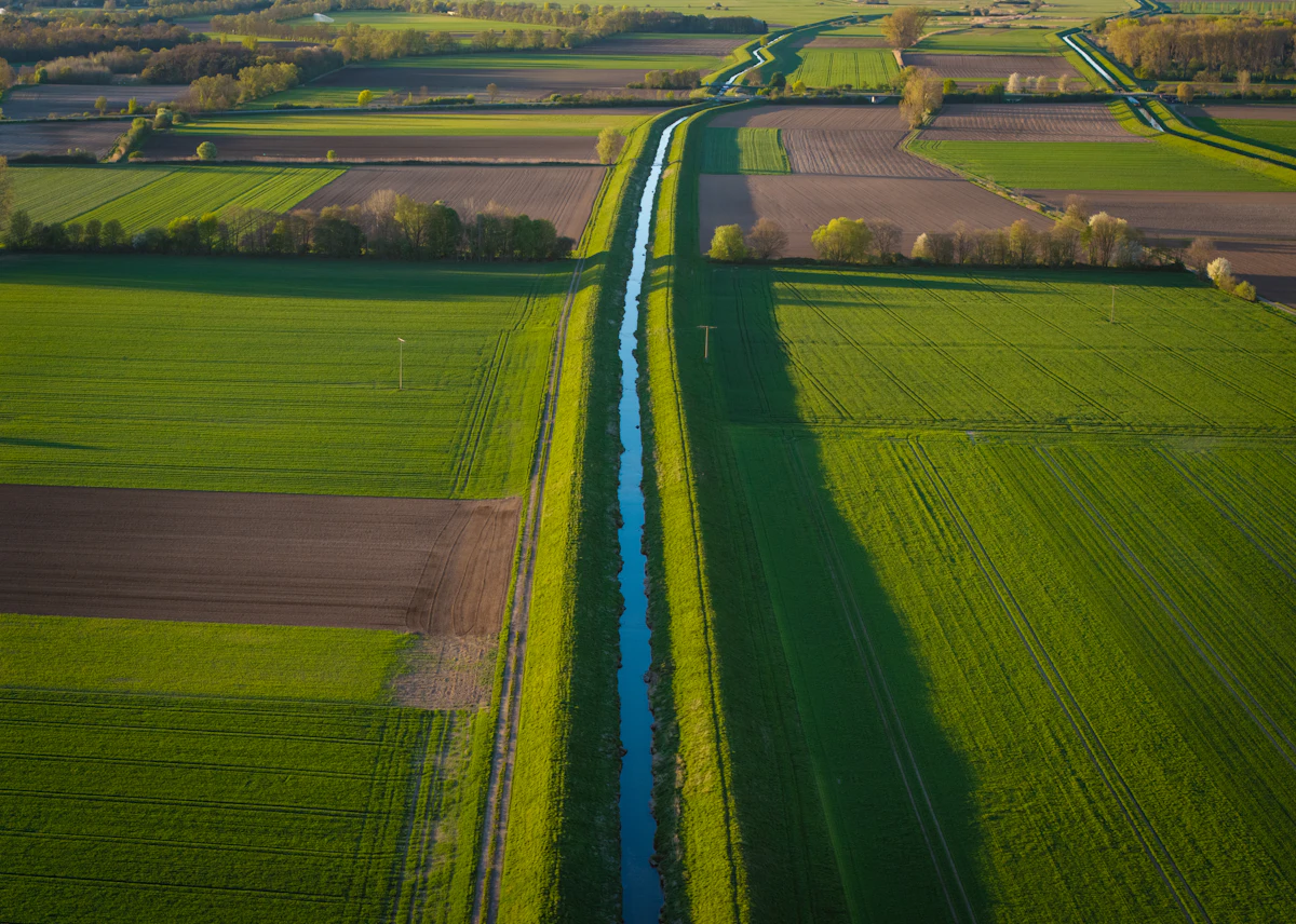 Aerial straight canal through fields