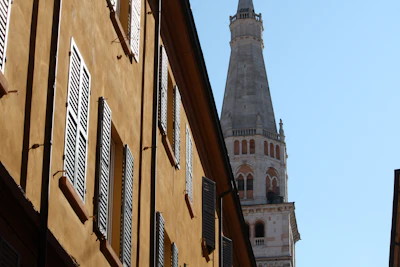 A tall church spire seen between buildings