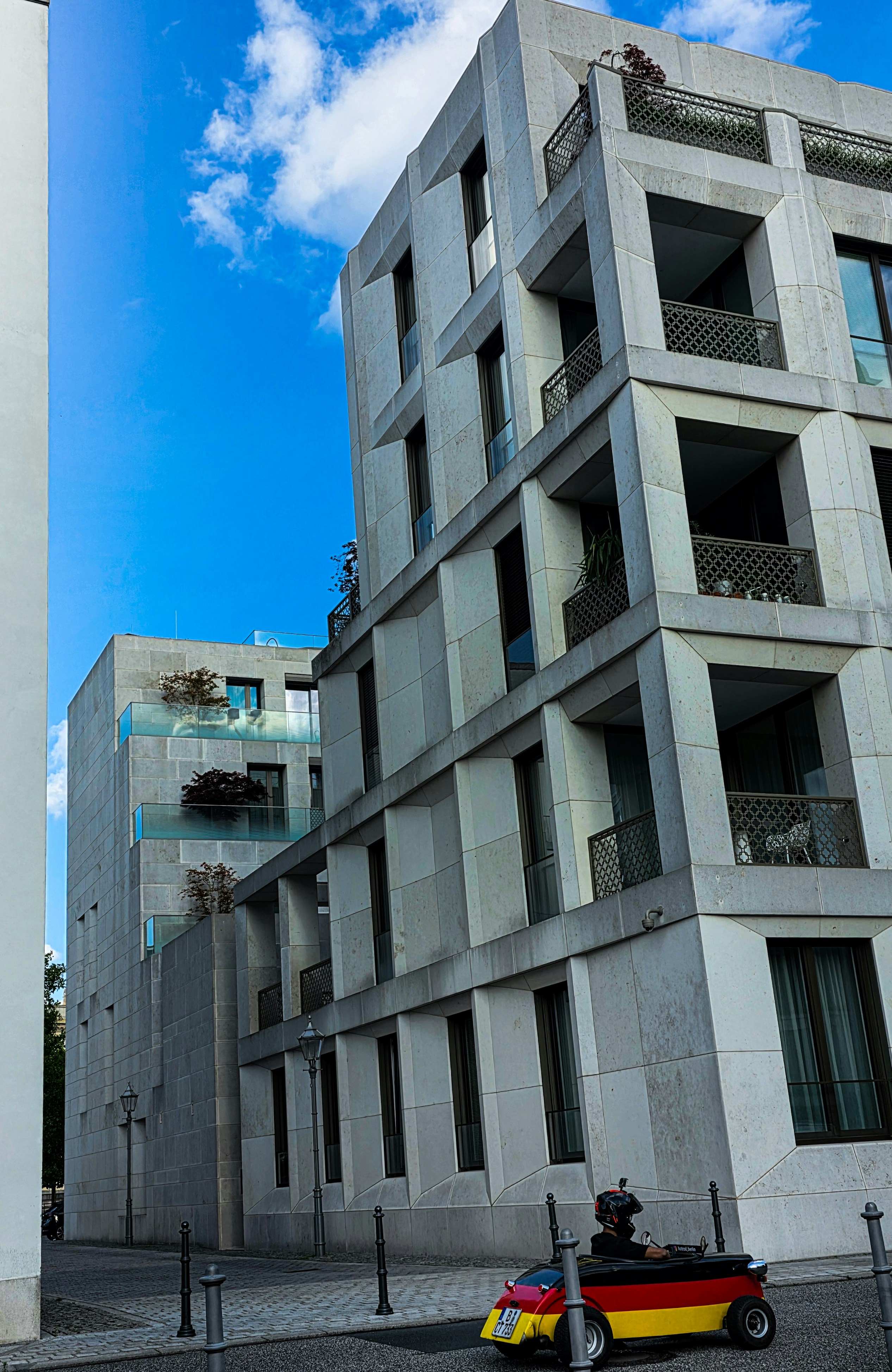 Modern concrete buildings with balconies against blue sky