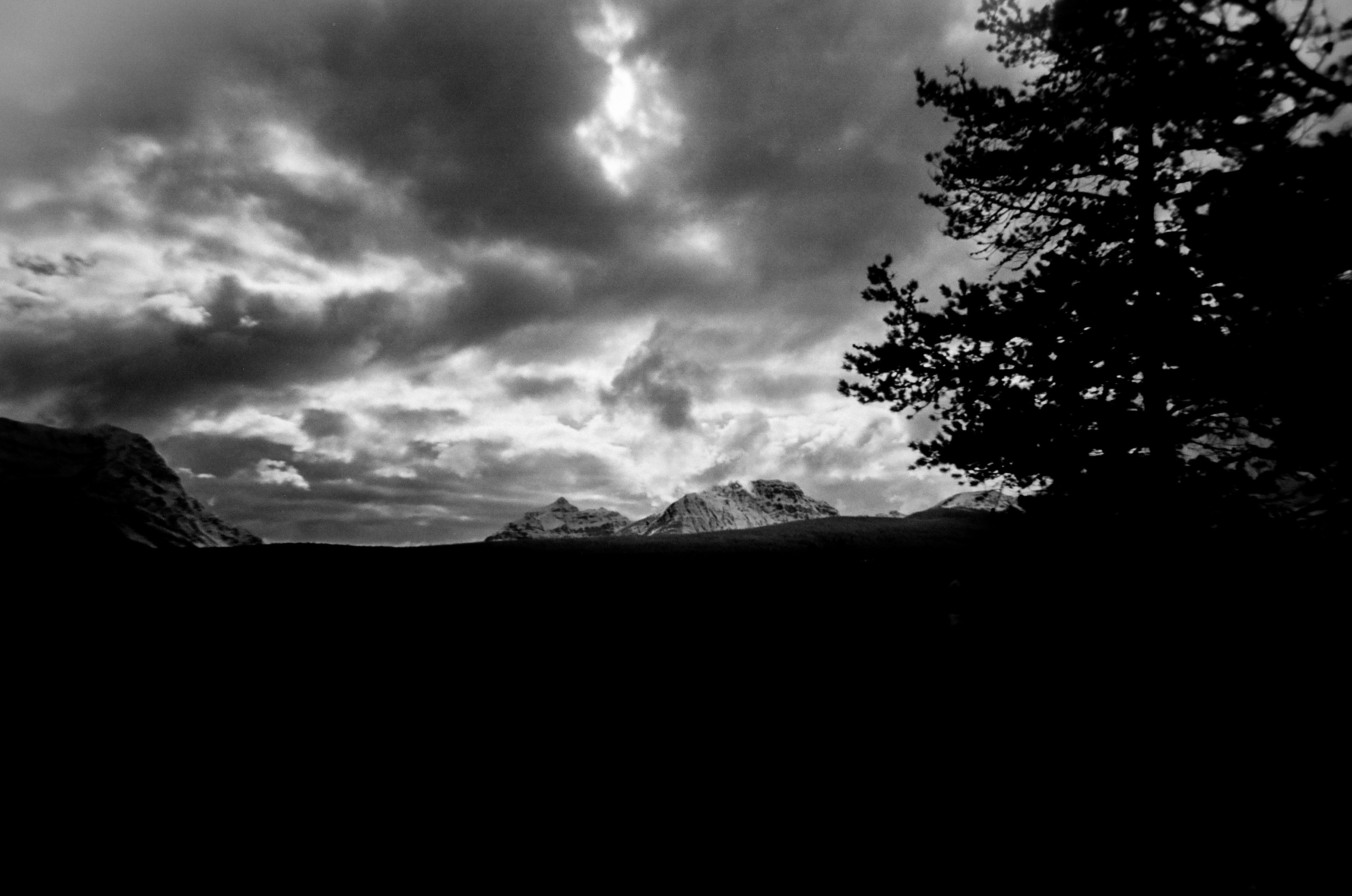 Dramatic clouds over distant mountains at dusk