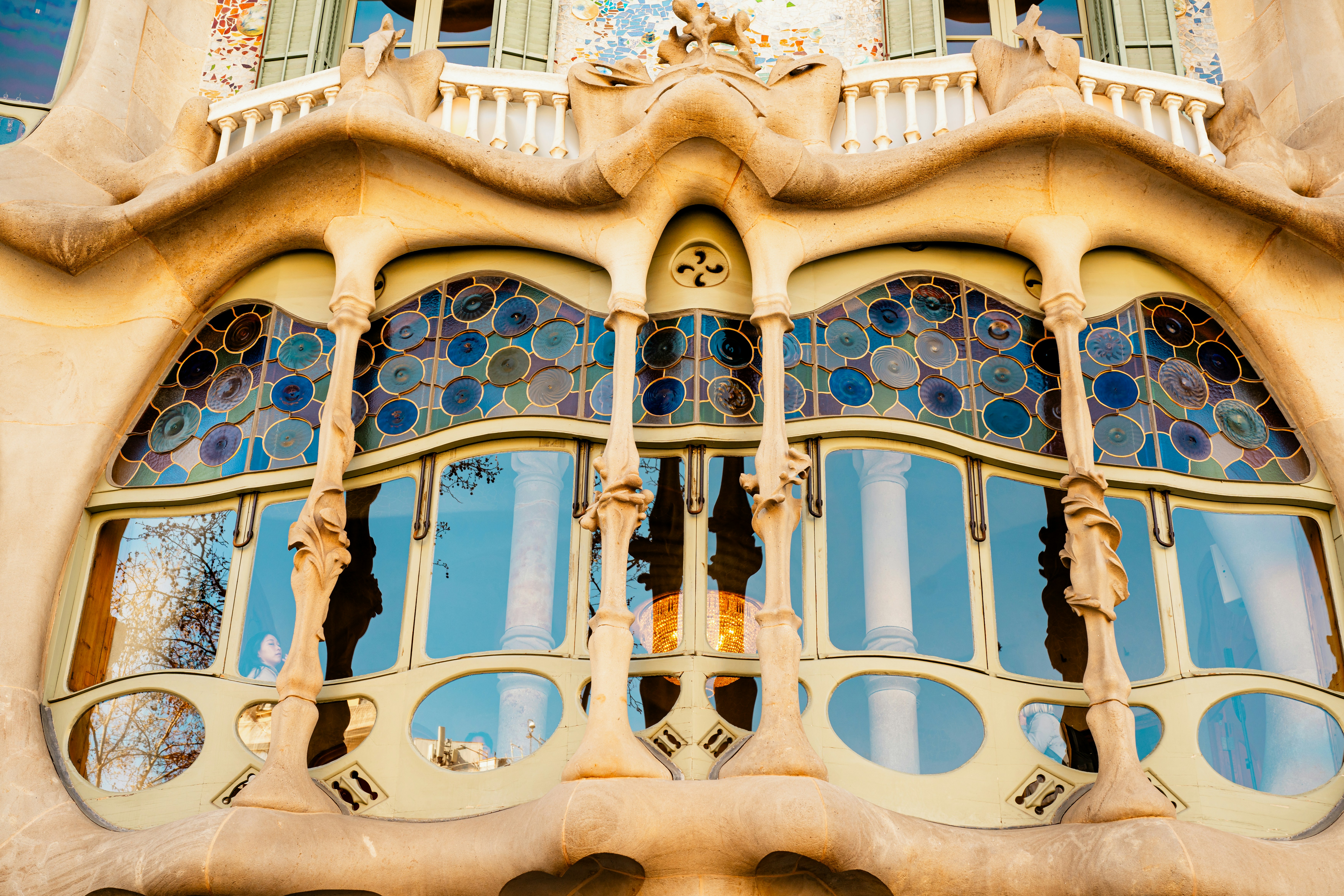 Ornate facade of a building with stained glass windows.