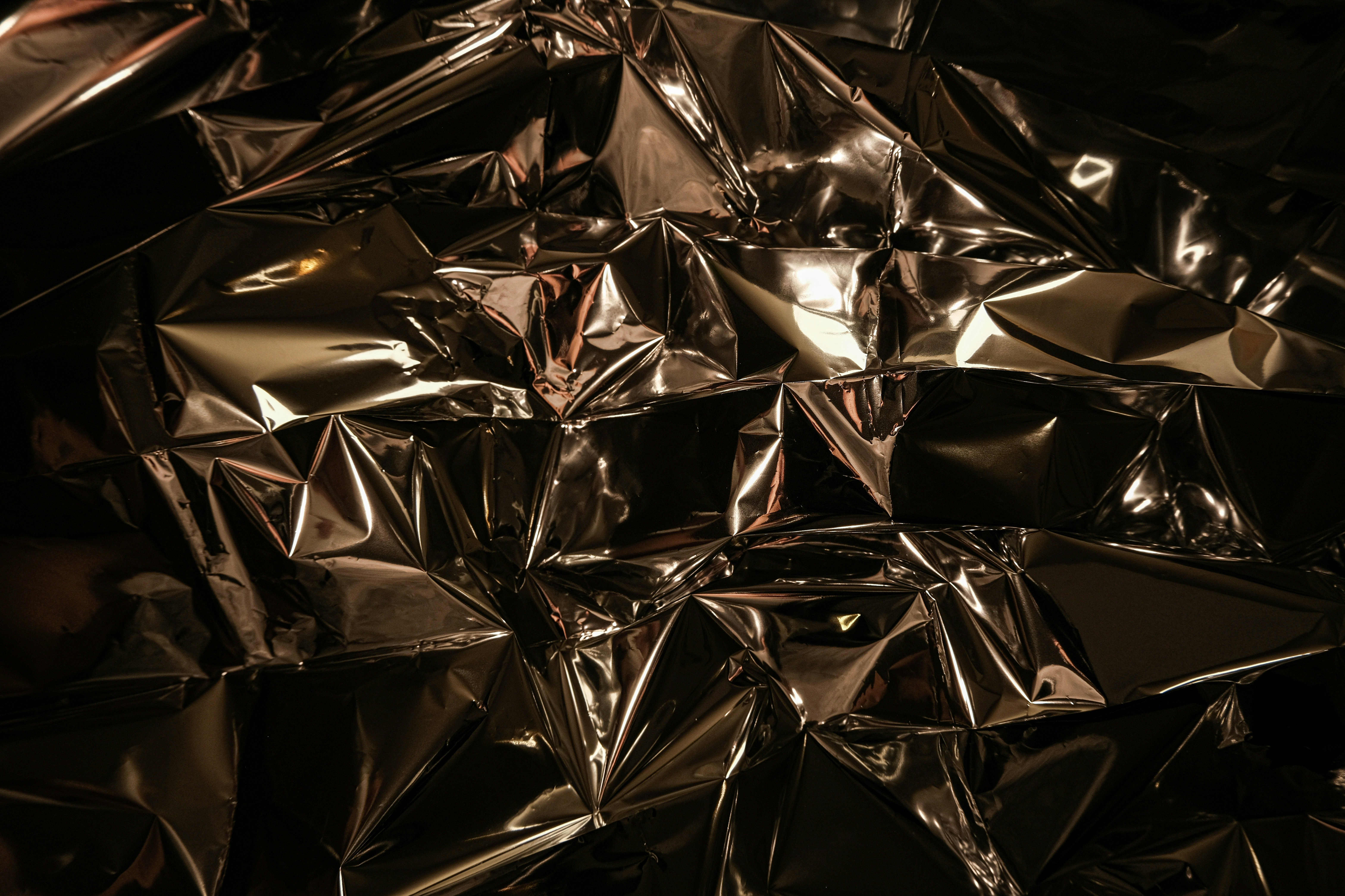 Crinkled metallic surface with dramatic lighting