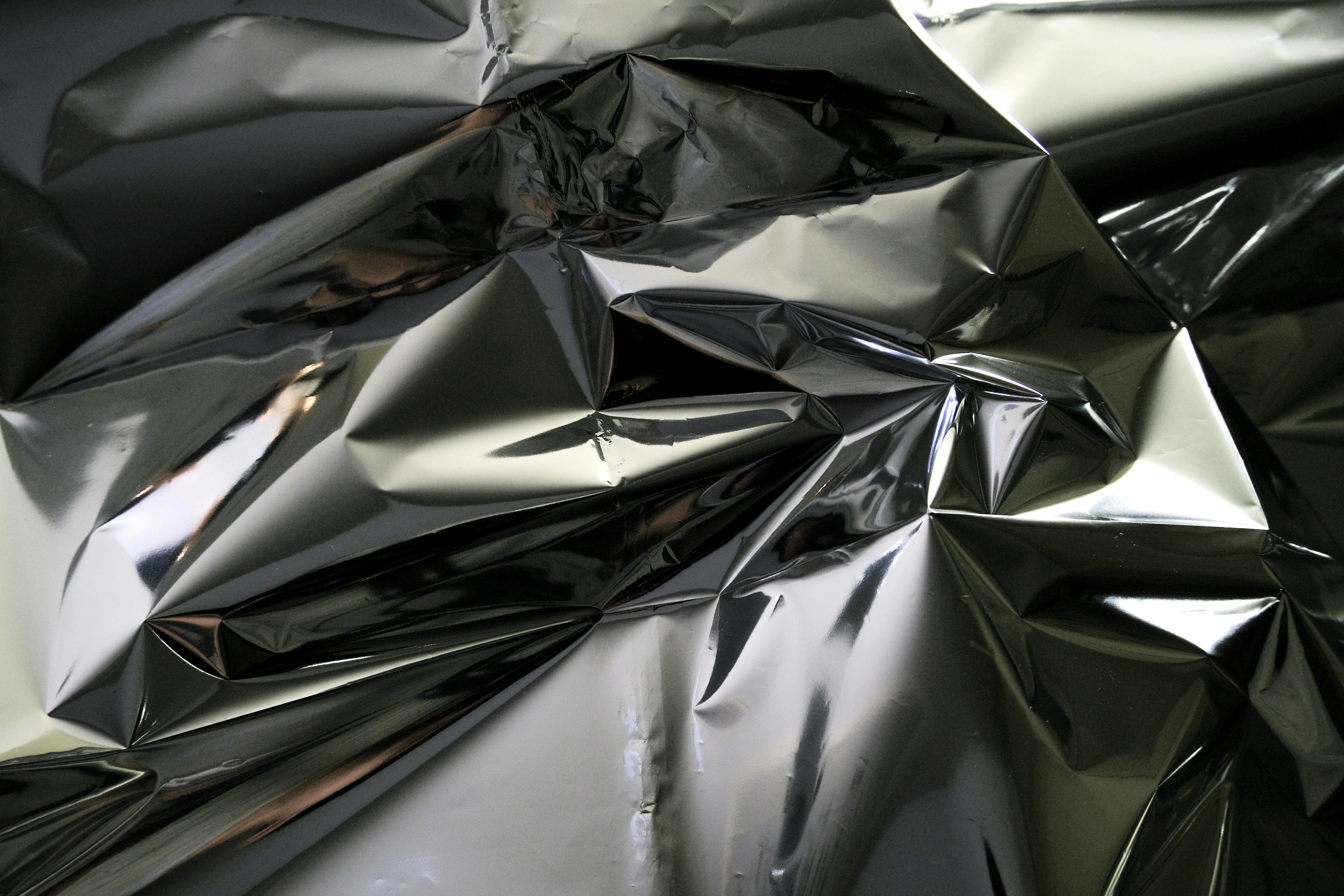 Crinkled metallic surface reflecting light