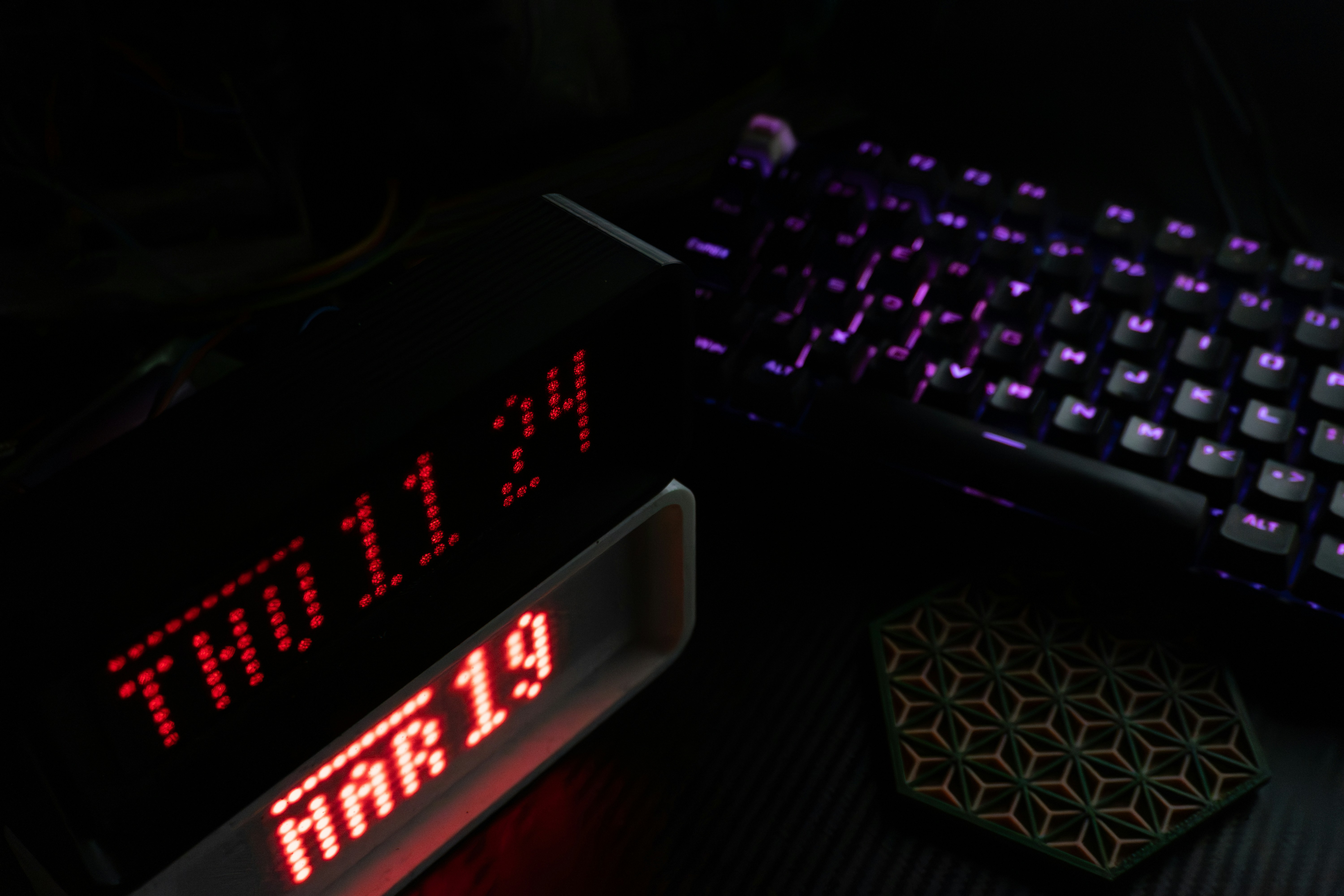 Digital clock displays date and time next to keyboard