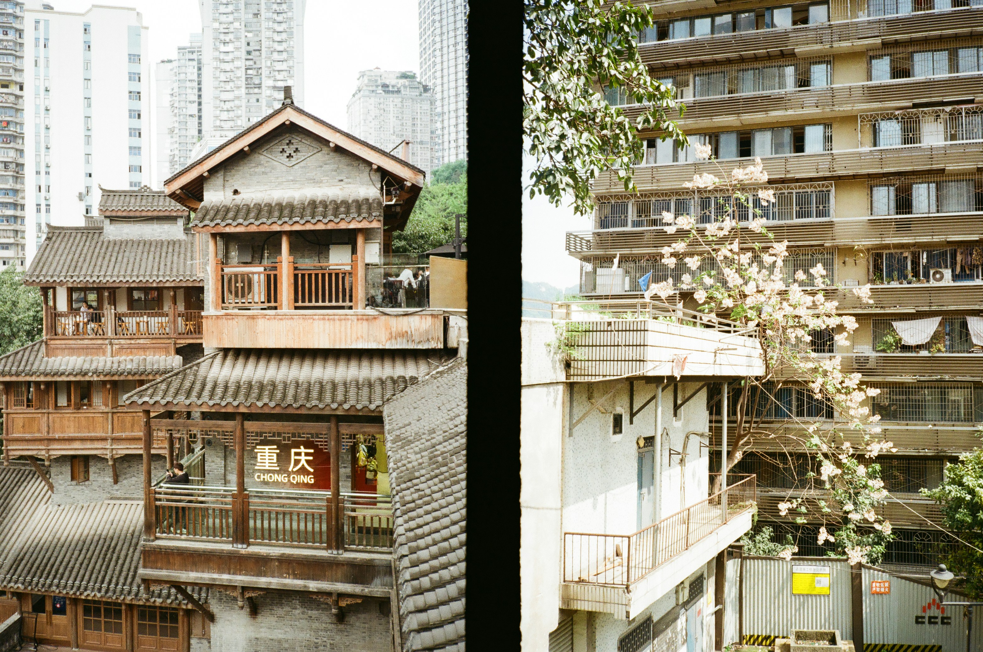 Traditional wooden buildings next to modern apartments