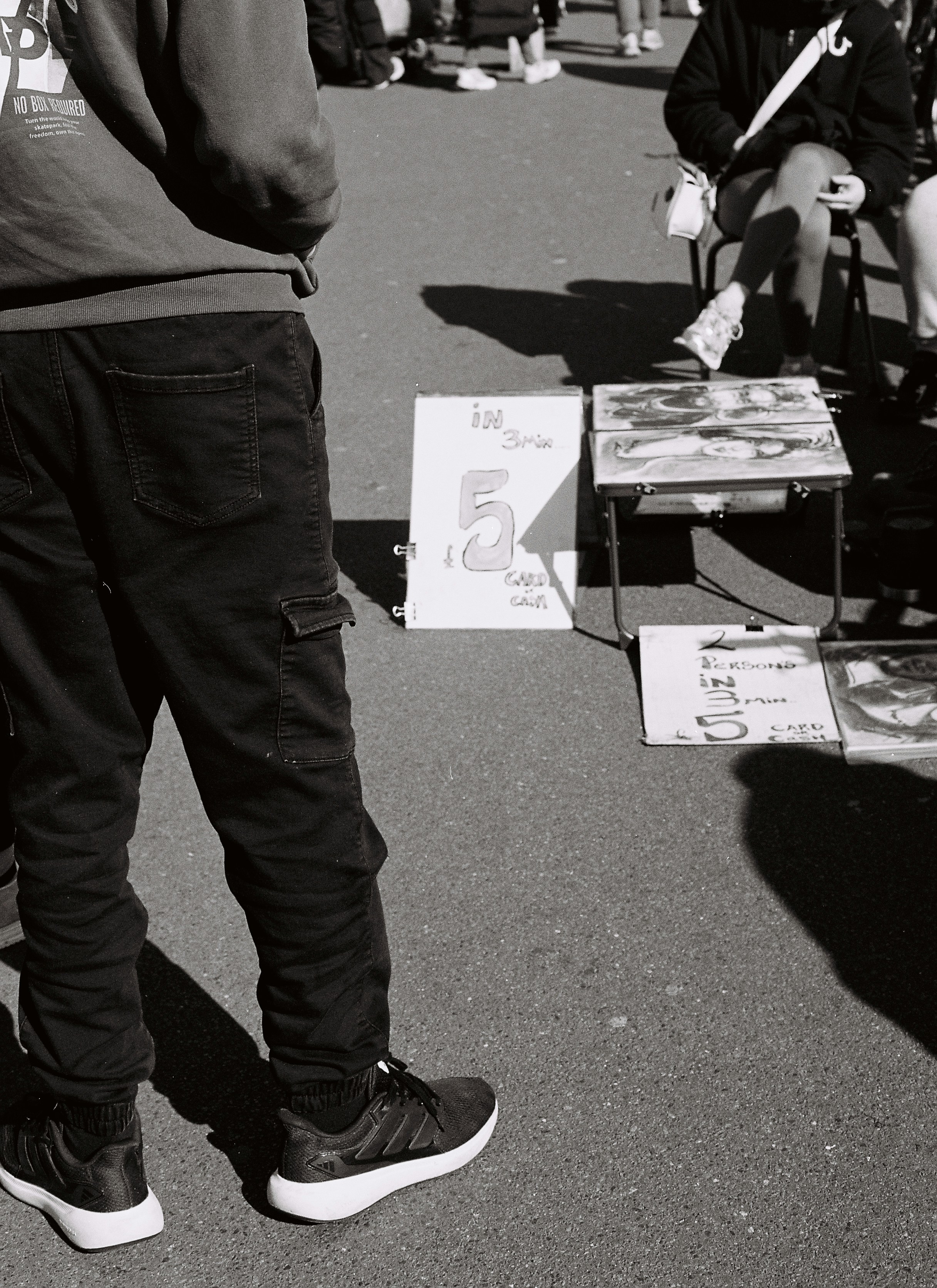 People gathered around a table with items for sale