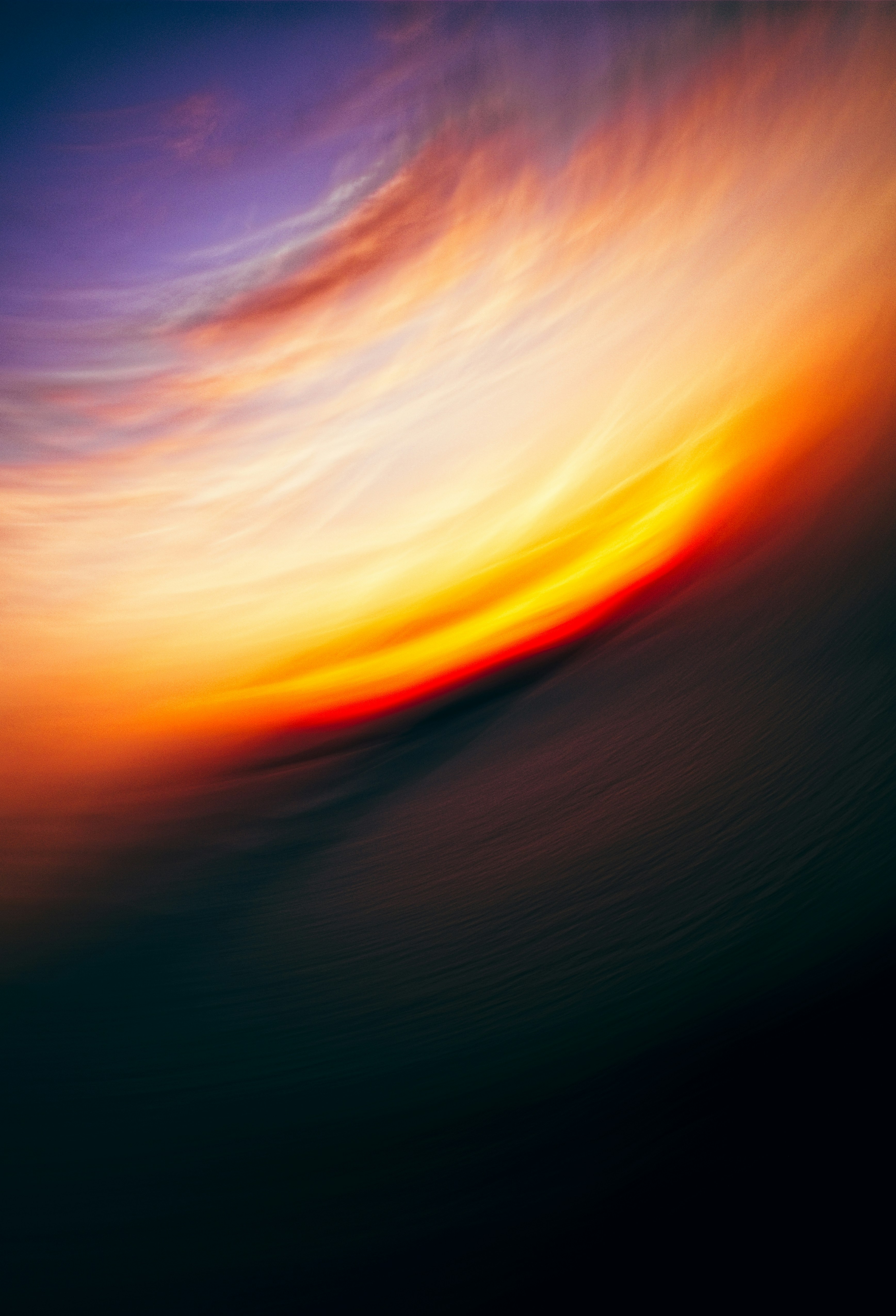 Abstract swirling clouds at sunset with vibrant colors