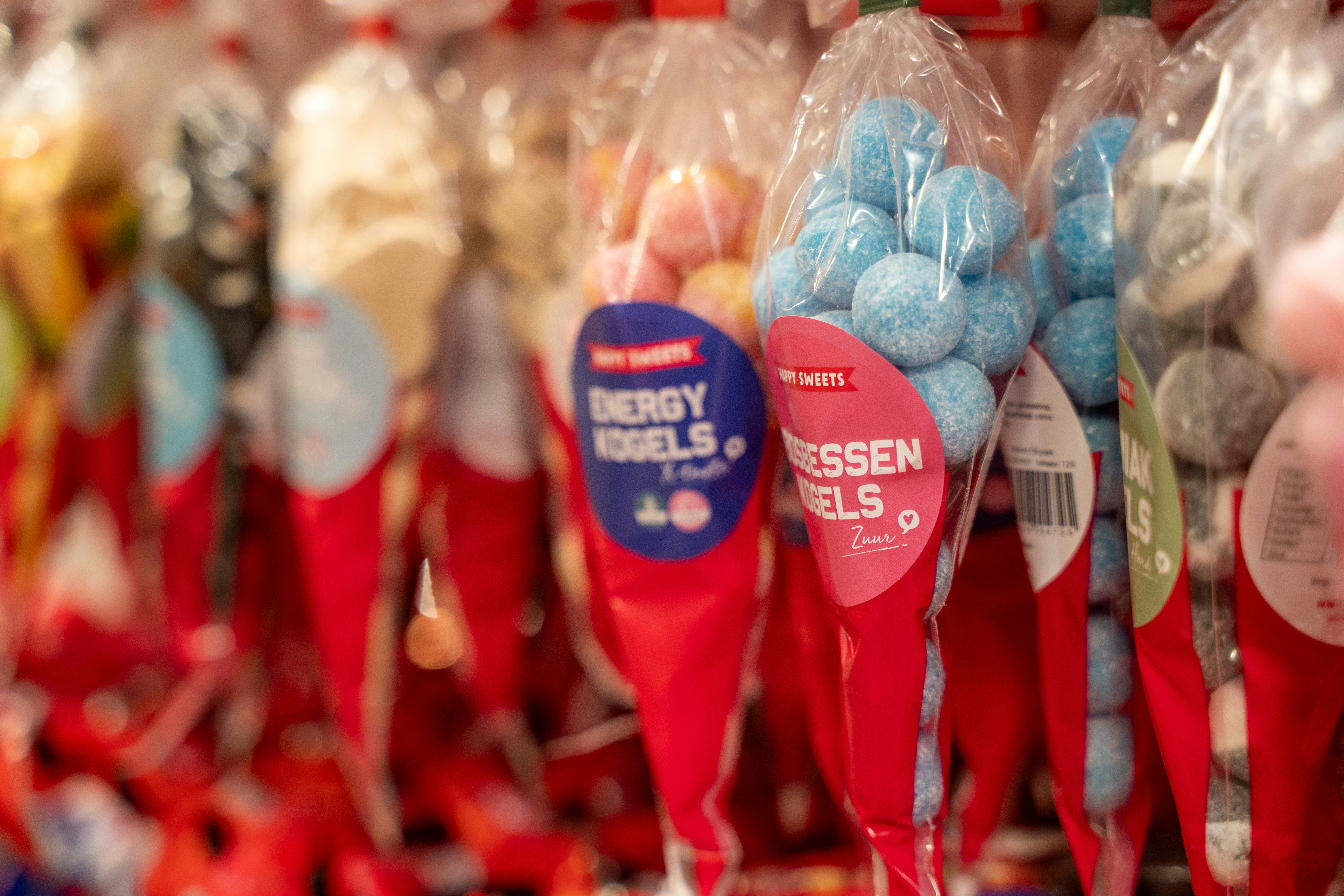 Wrapped candy cones with colorful sweets inside.