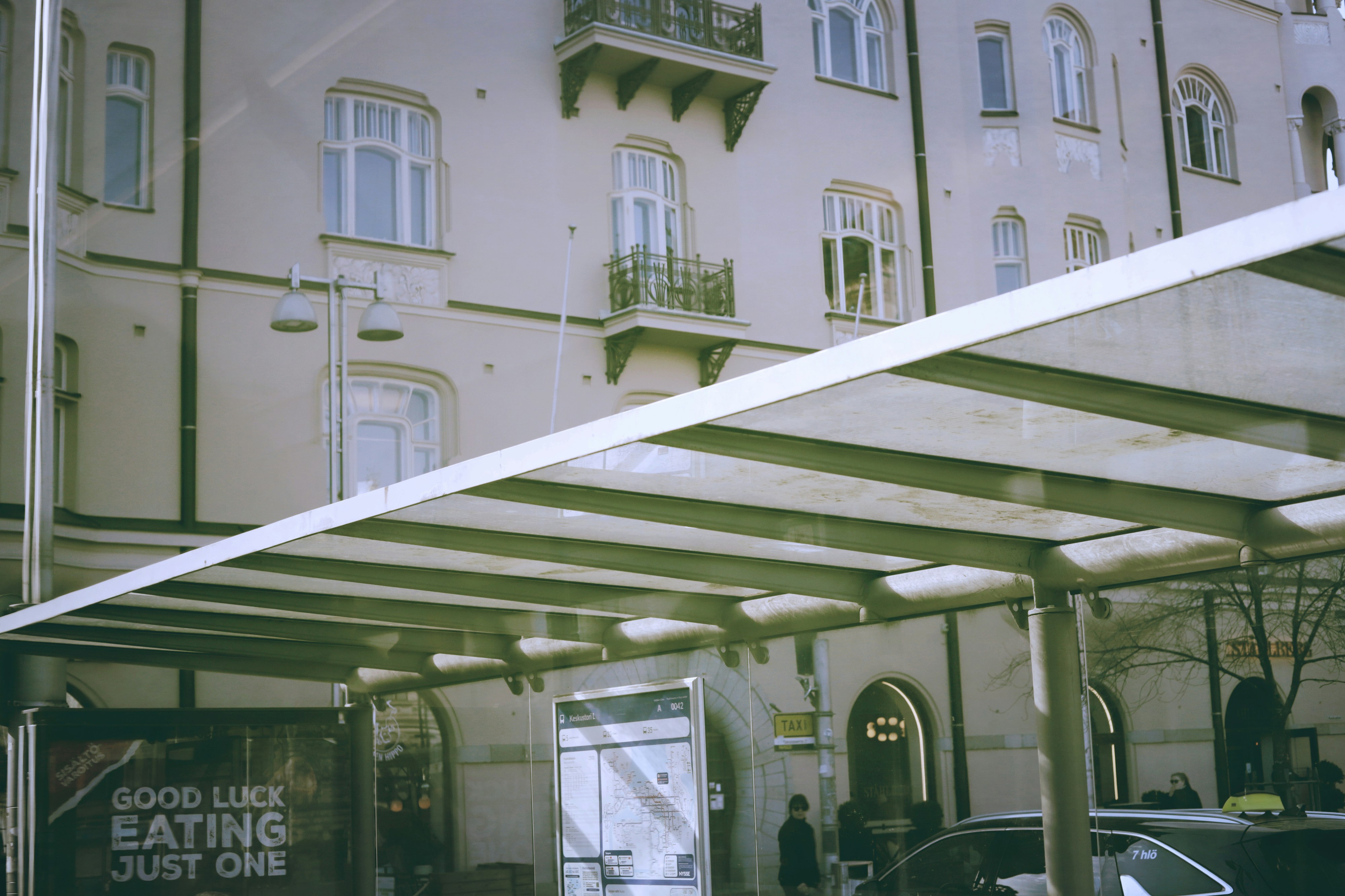Building with canopy and cars on-street parking