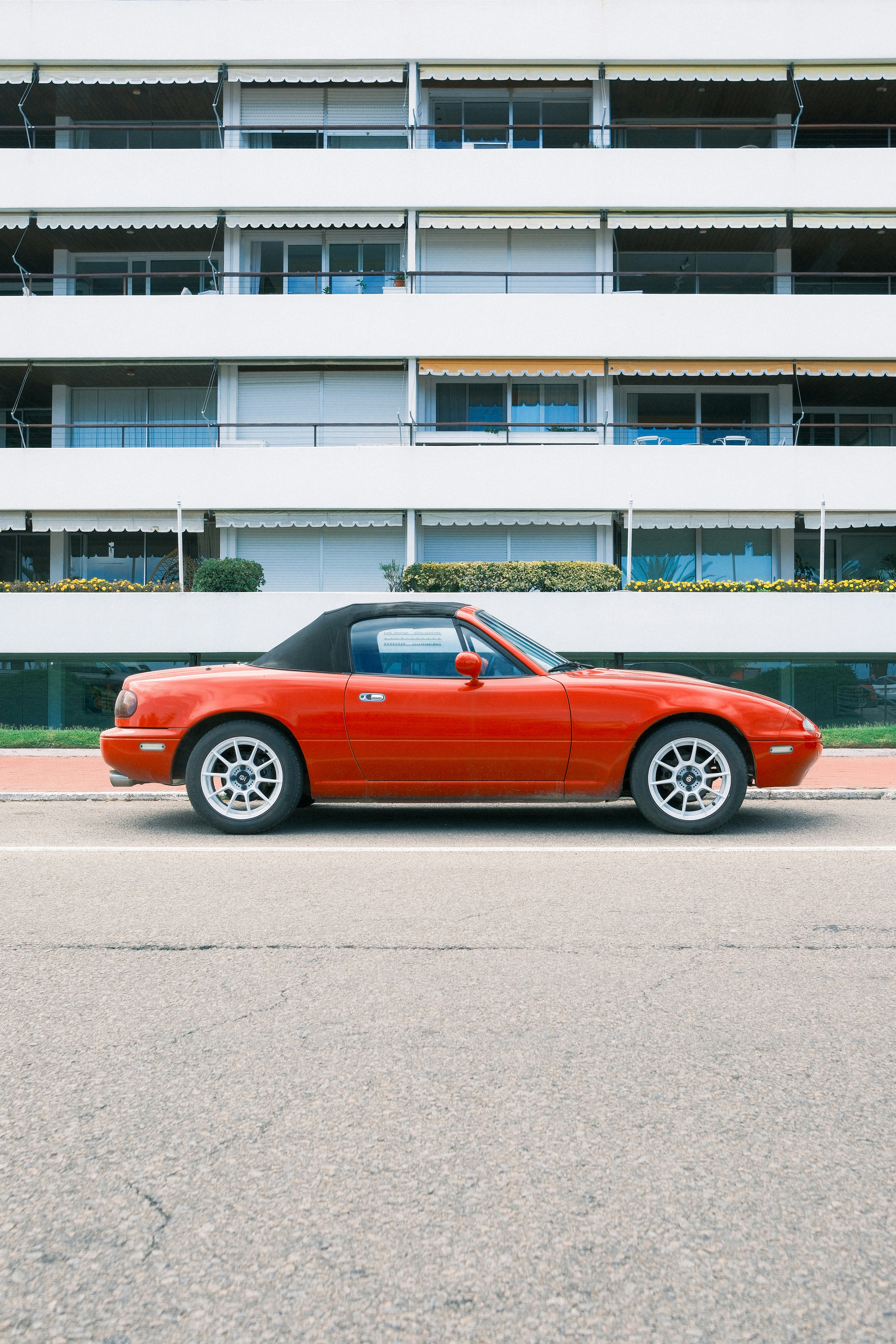 Red convertible sports car parked on street