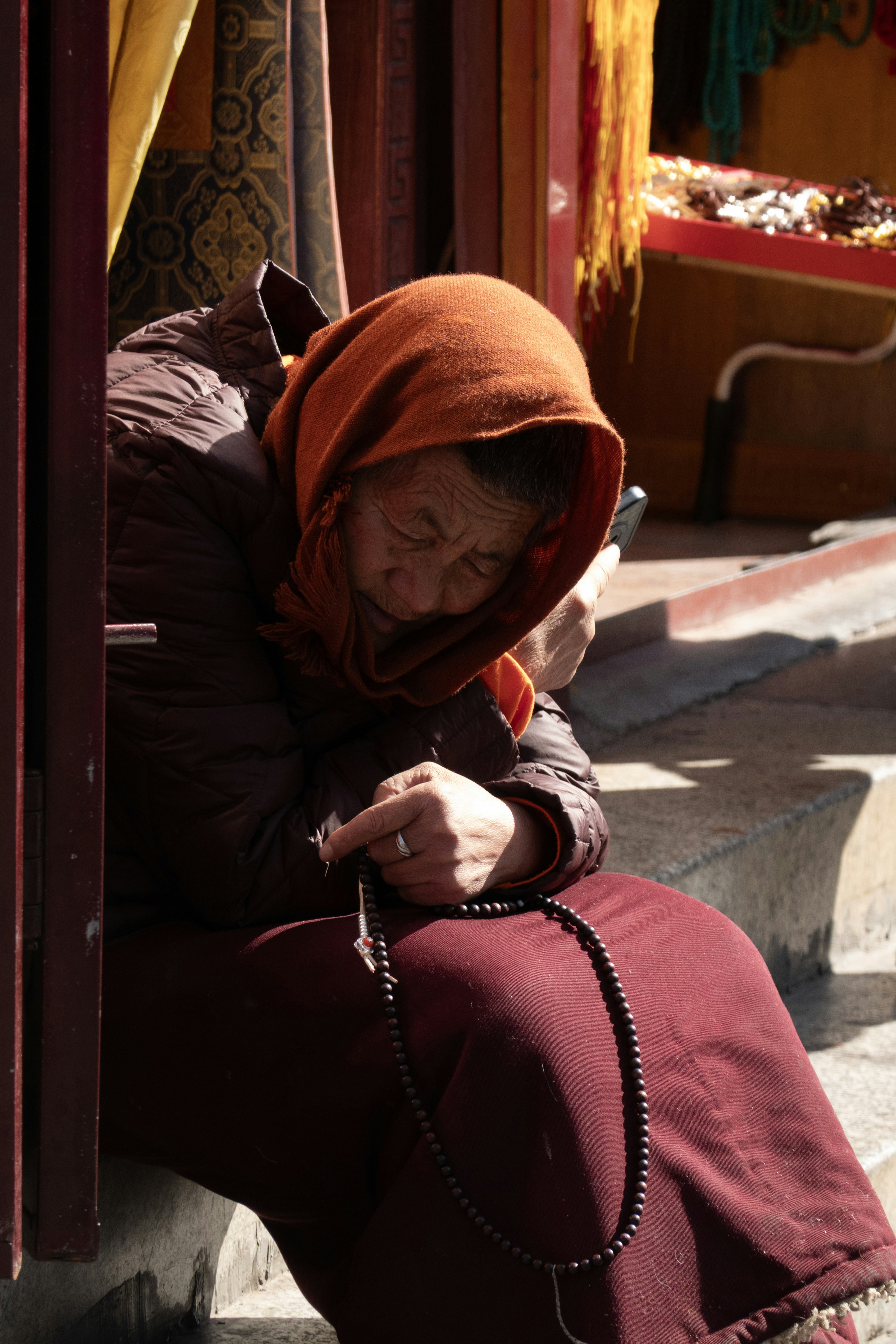 Buddhist monk with prayer beads and phone