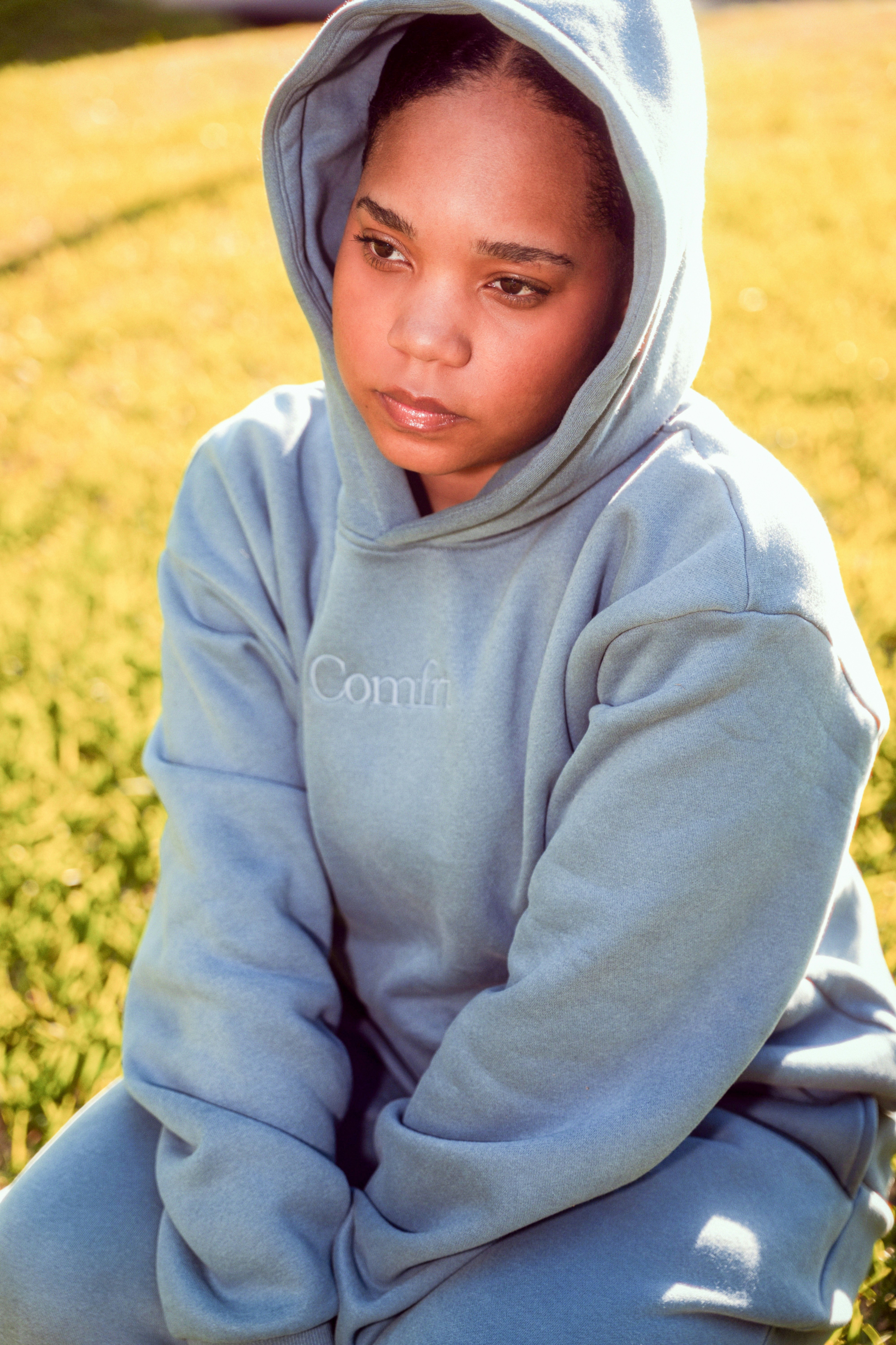 Young girl in a light blue hoodie outdoors