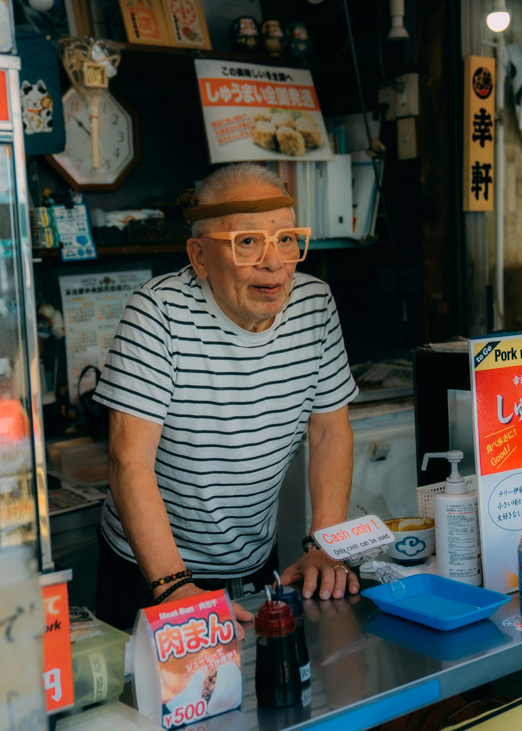 Elderly man with glasses at a food stall