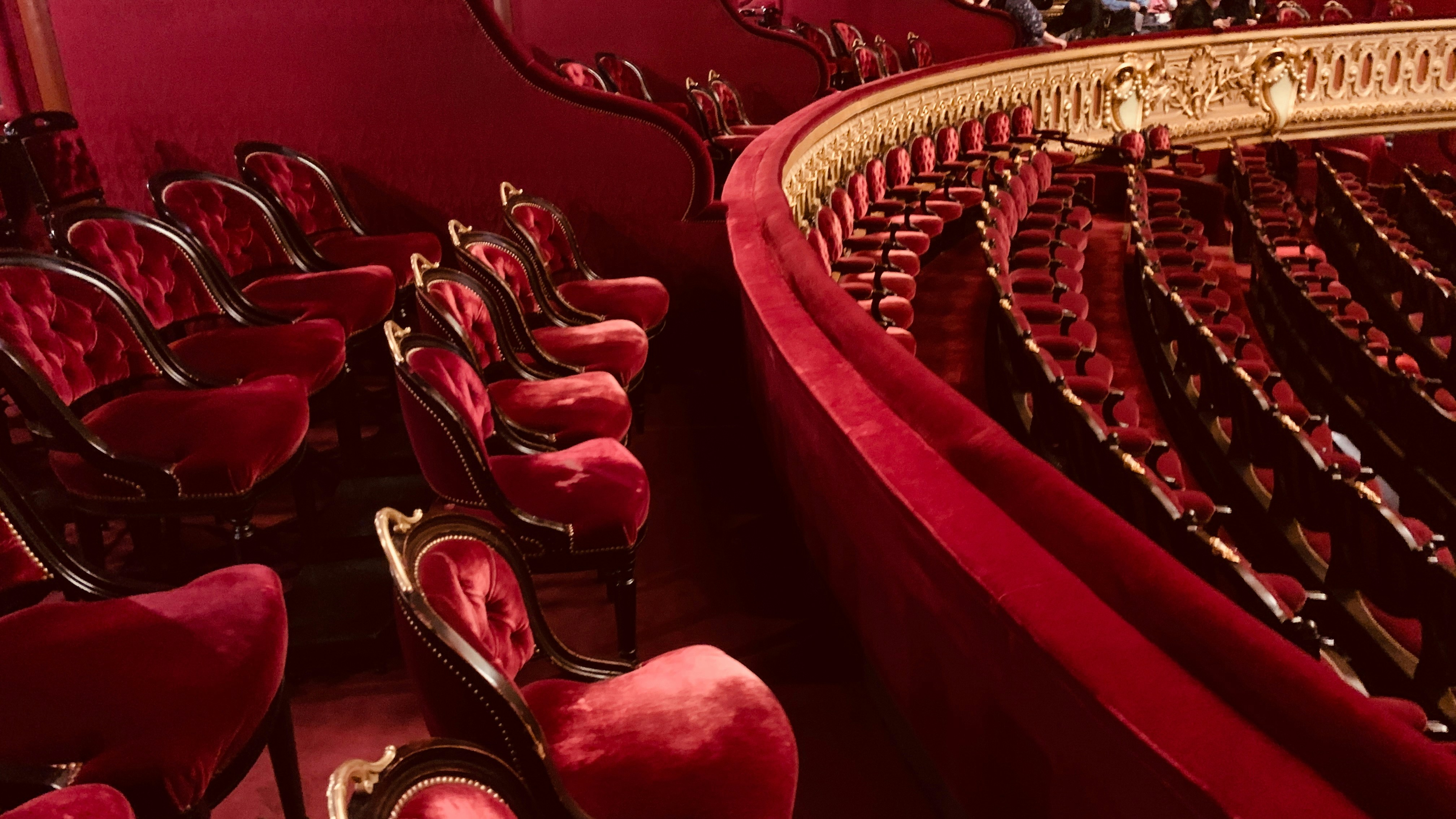 Luxurious red velvet seats in an ornate theater