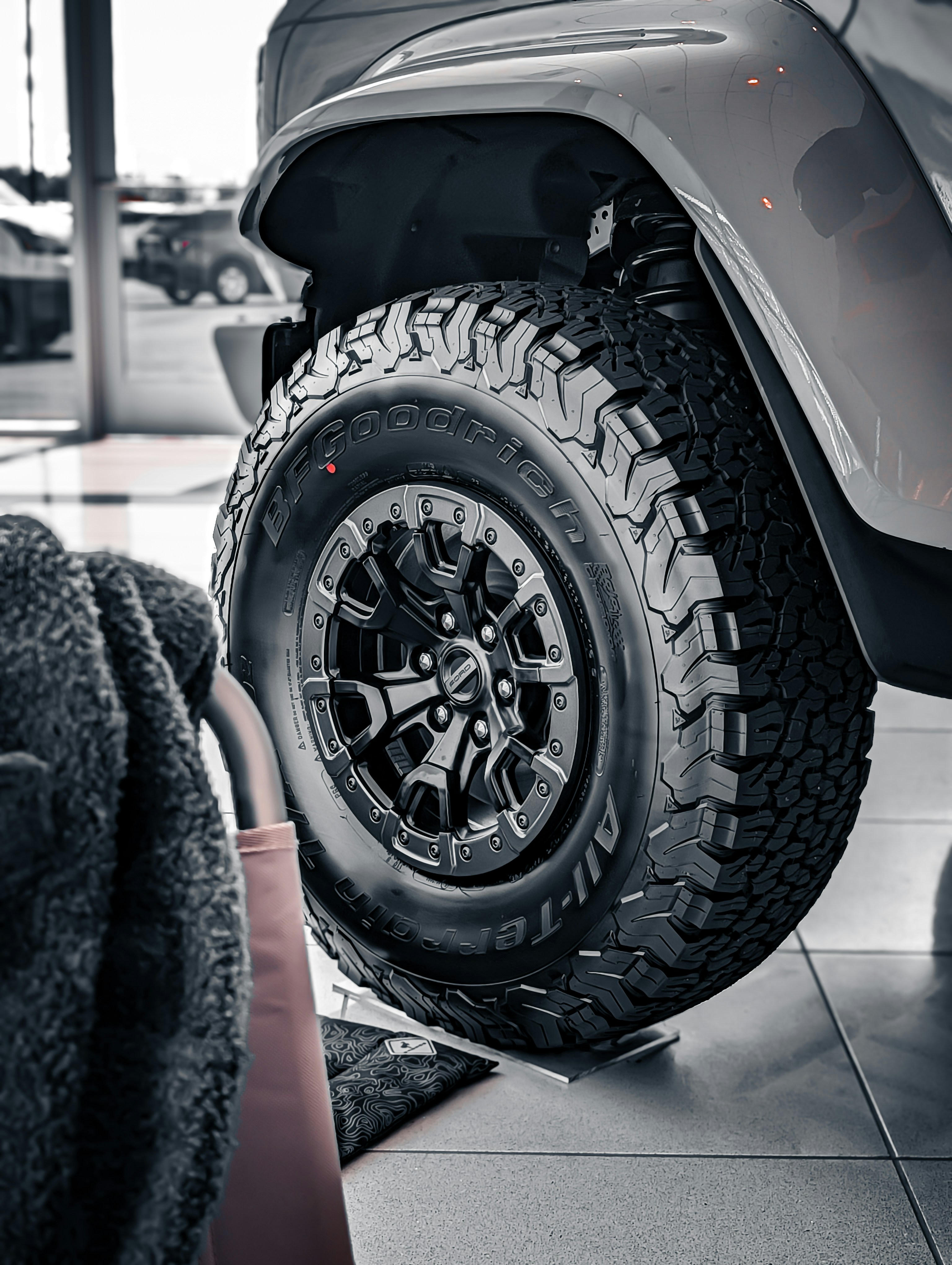 Close-up of a rugged off-road tire on a vehicle.