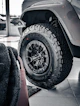 Close-up of a rugged off-road tire on a vehicle.