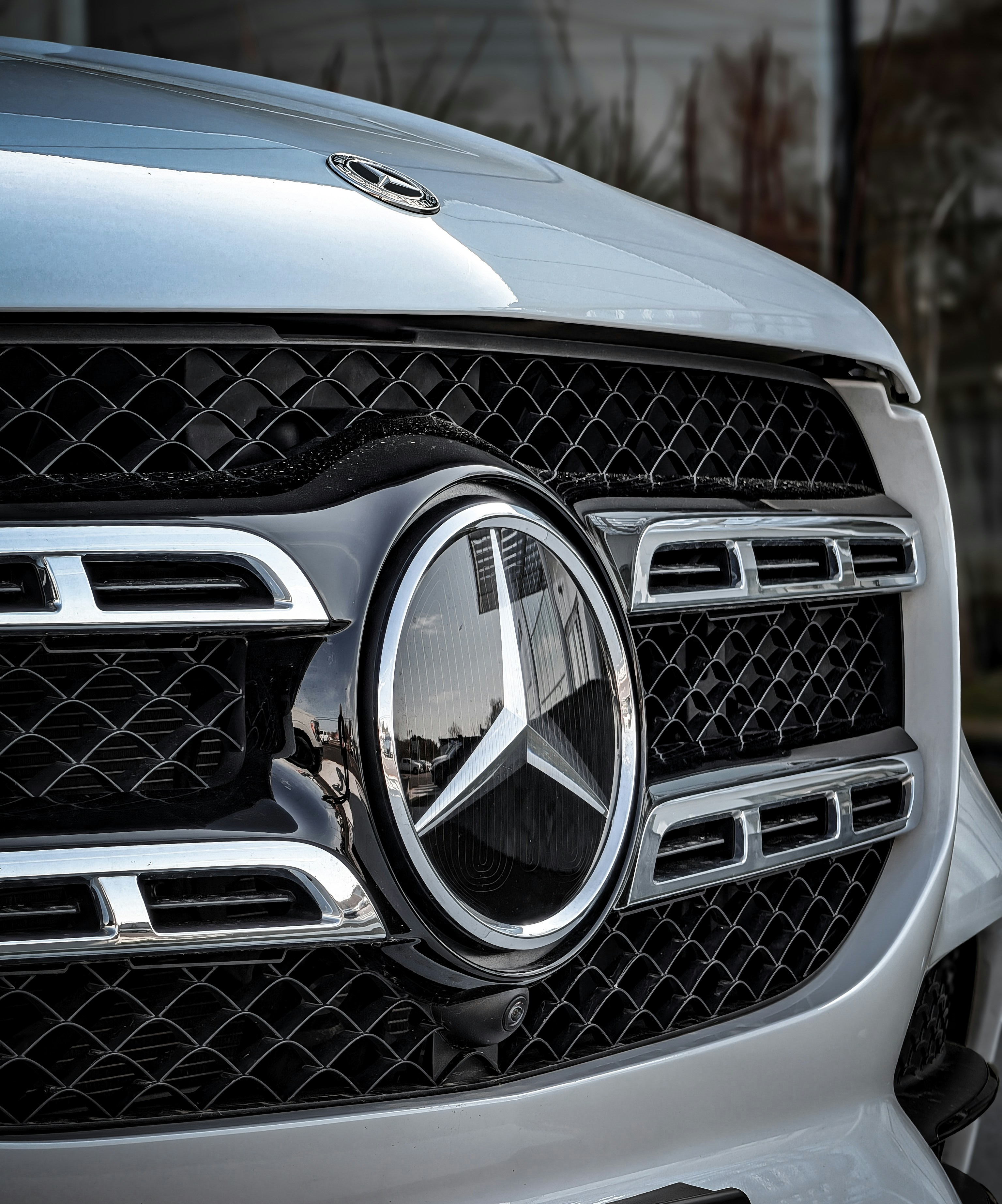 Close-up of a mercedes-benz grille with star logo.