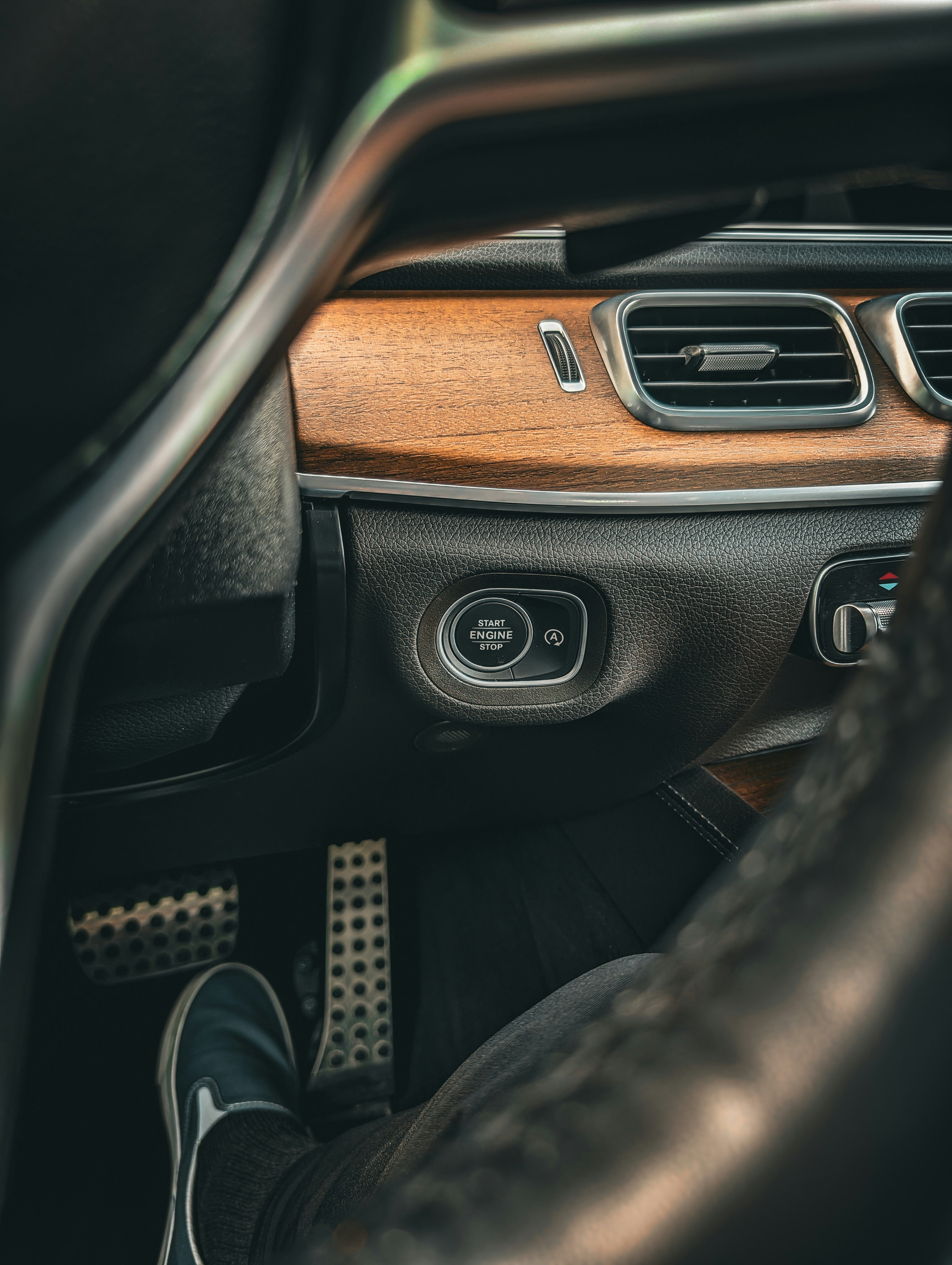 Close-up of a car's wooden dashboard and pedals