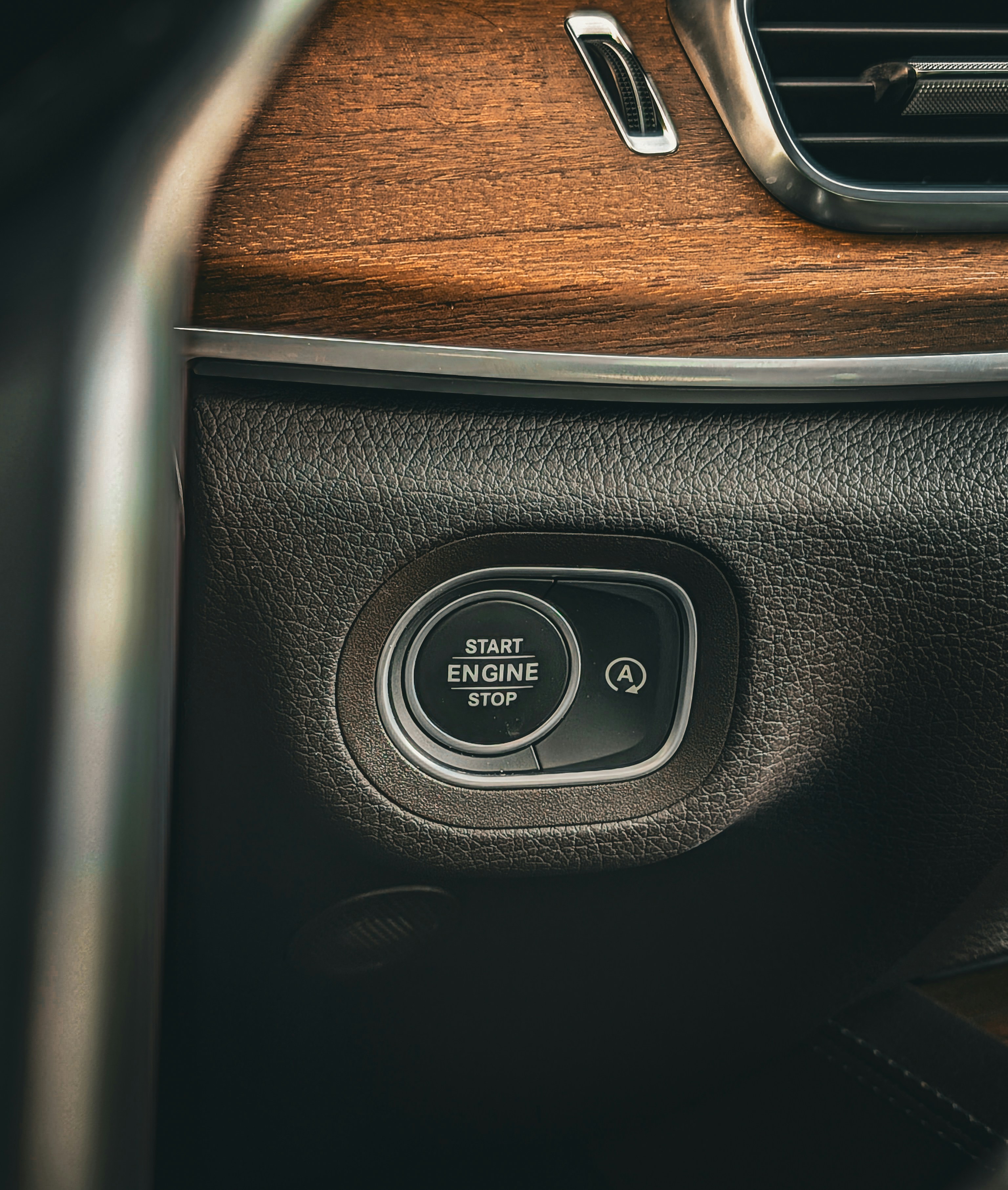 Close-up of a car's start engine stop button.