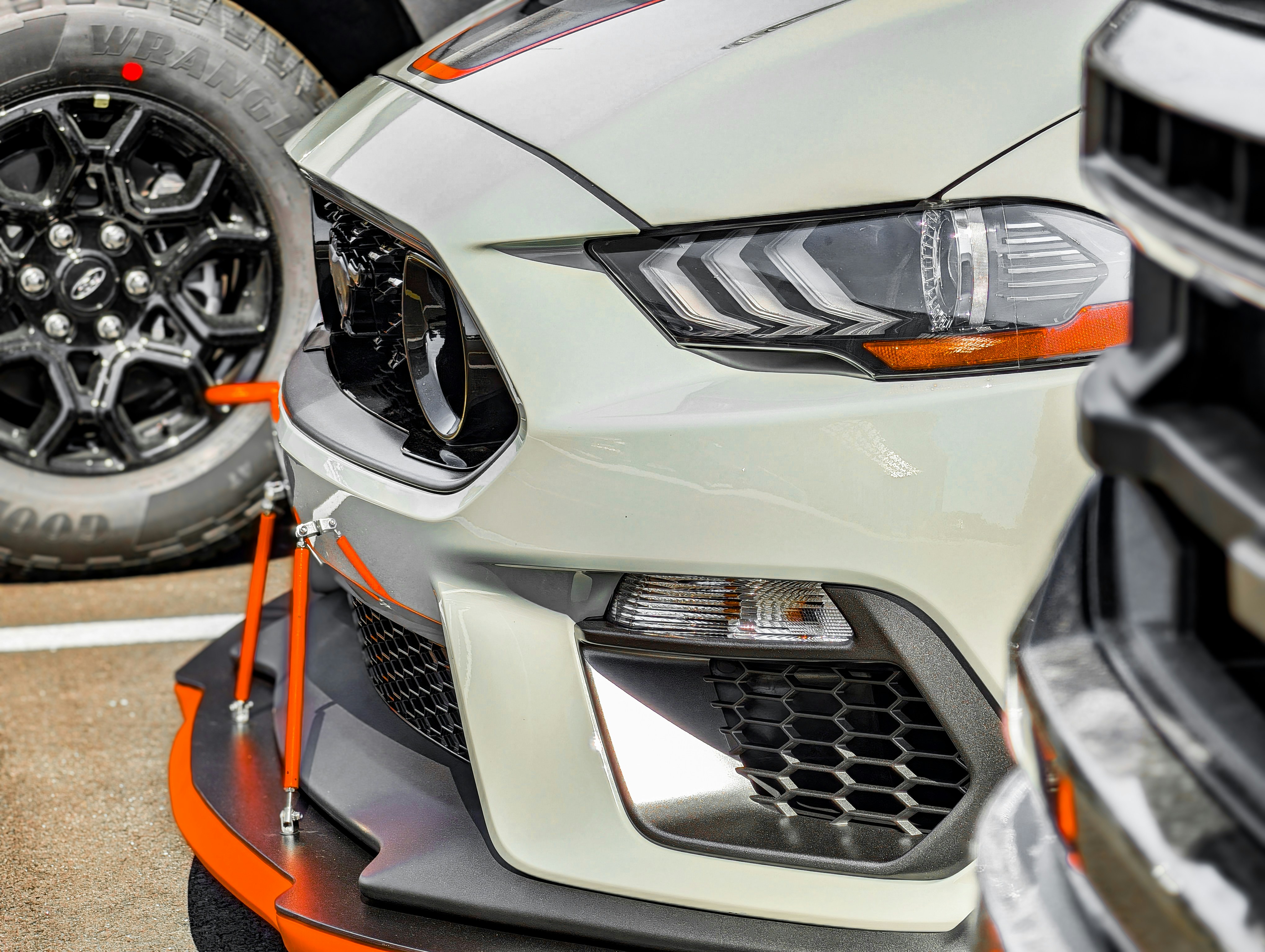 Close-up of a white sports car with orange accents.
