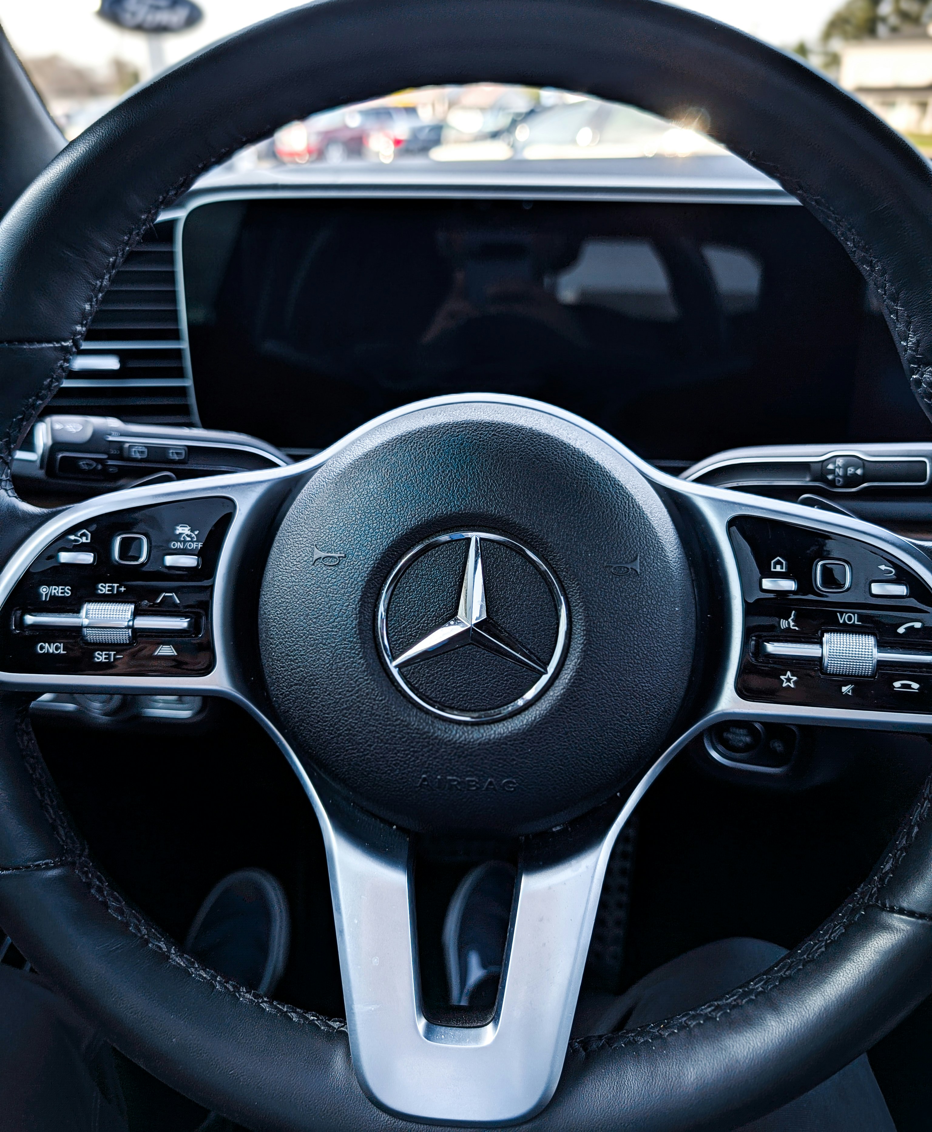 Close-up of a mercedes-benz steering wheel interior.