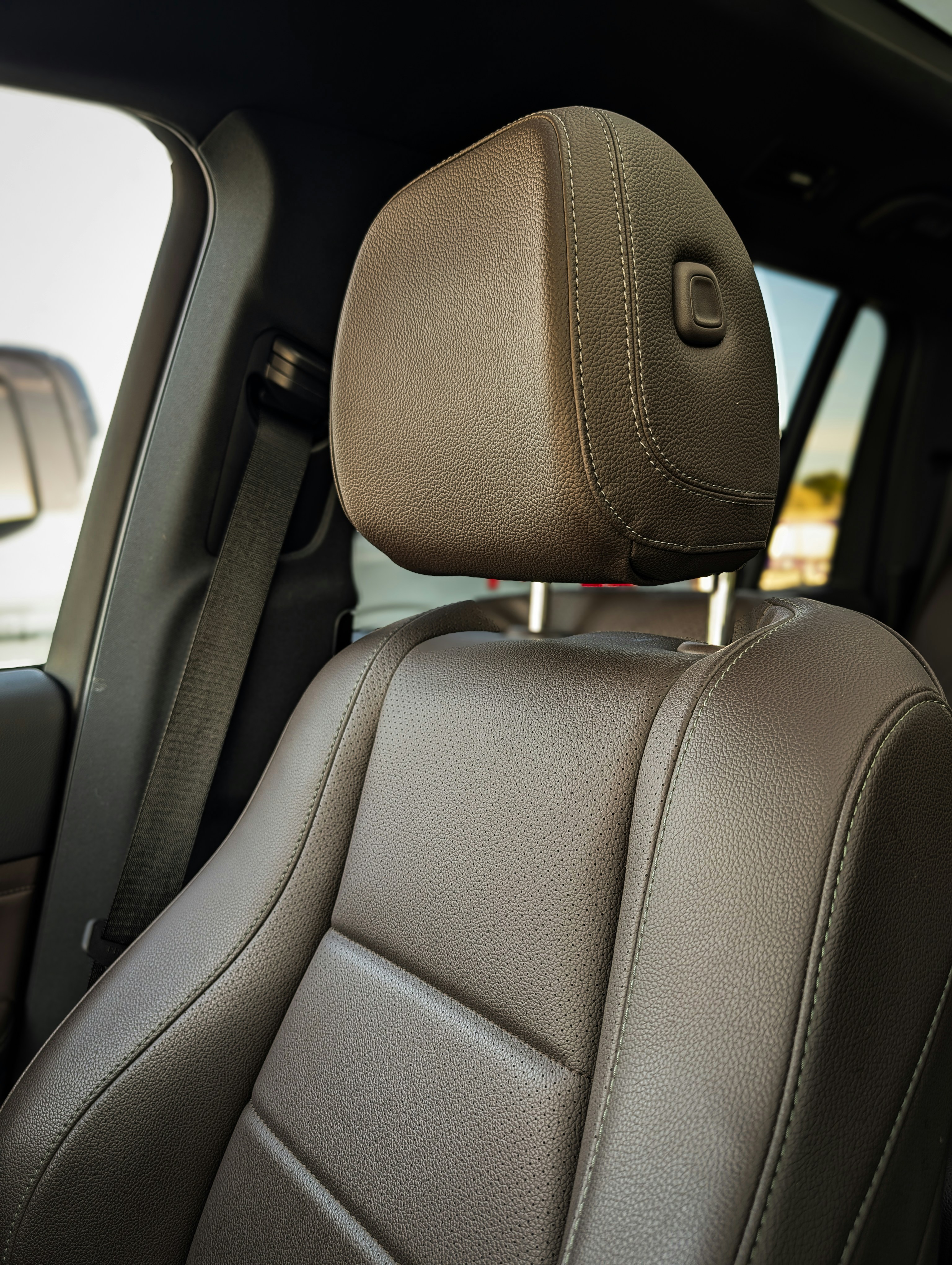 Close-up of a luxurious brown leather car seat.