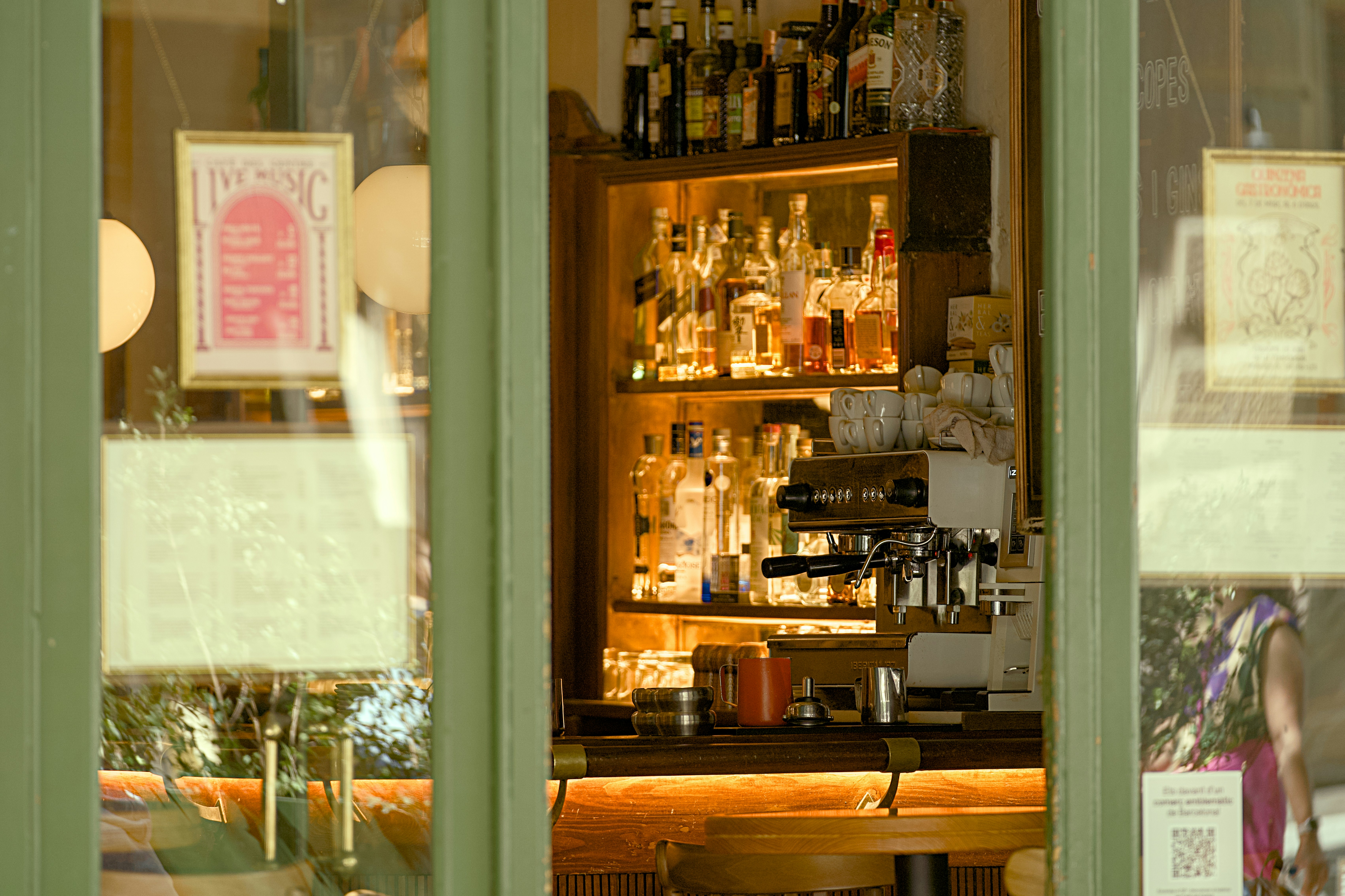 Bottles of alcohol displayed behind a bar counter.