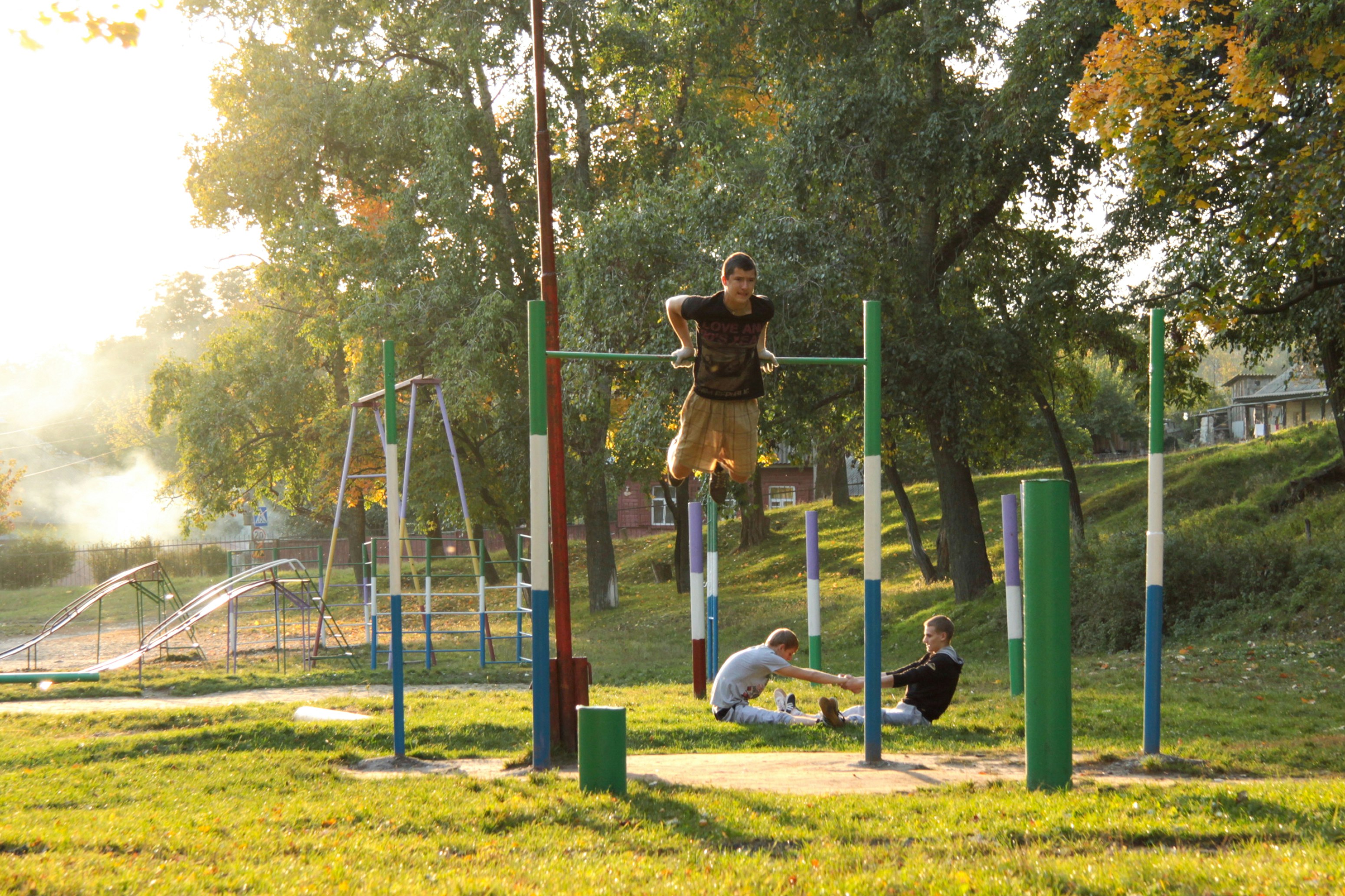 People exercising at an outdoor fitness park