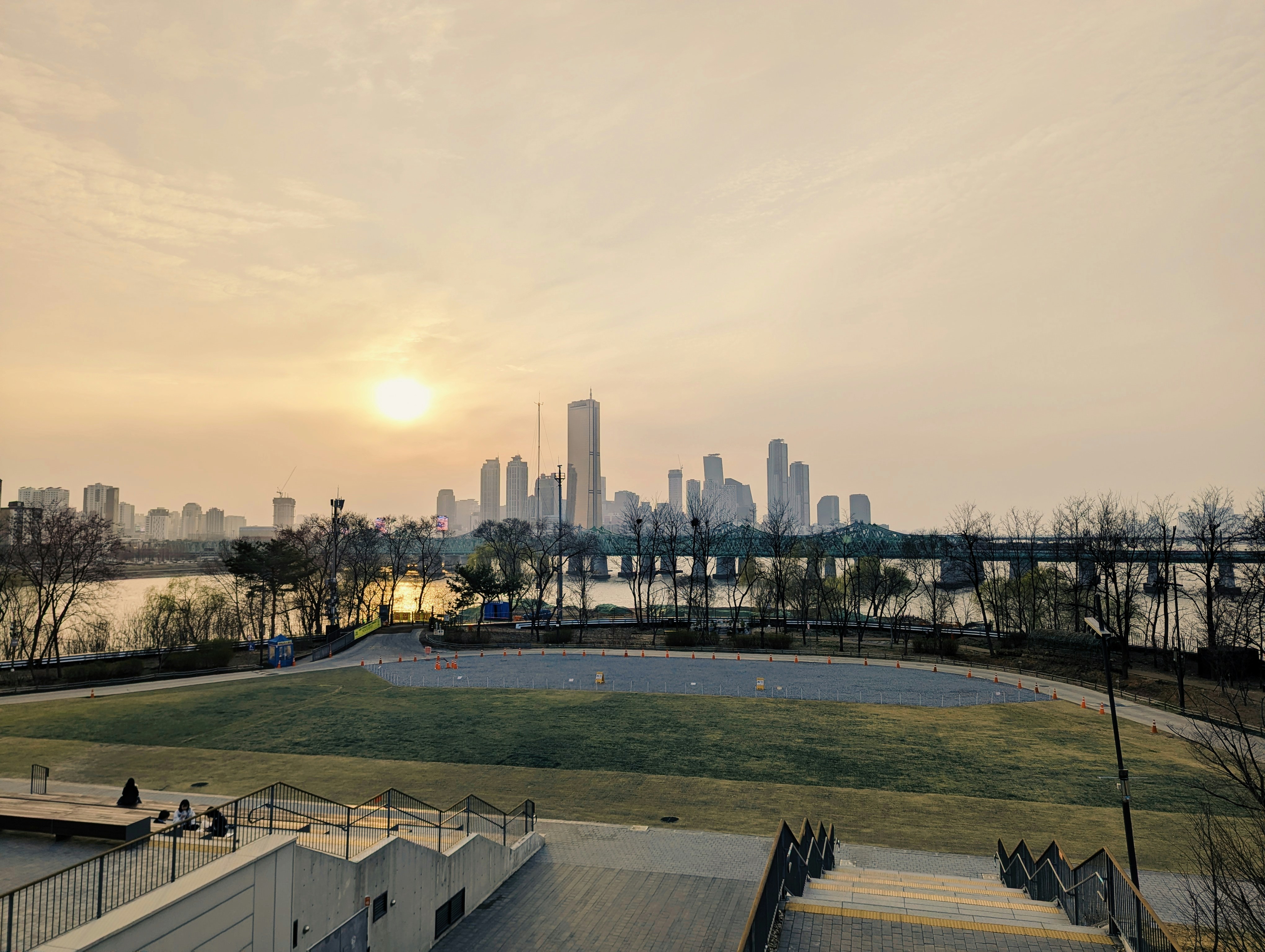 City skyline at sunrise over a river