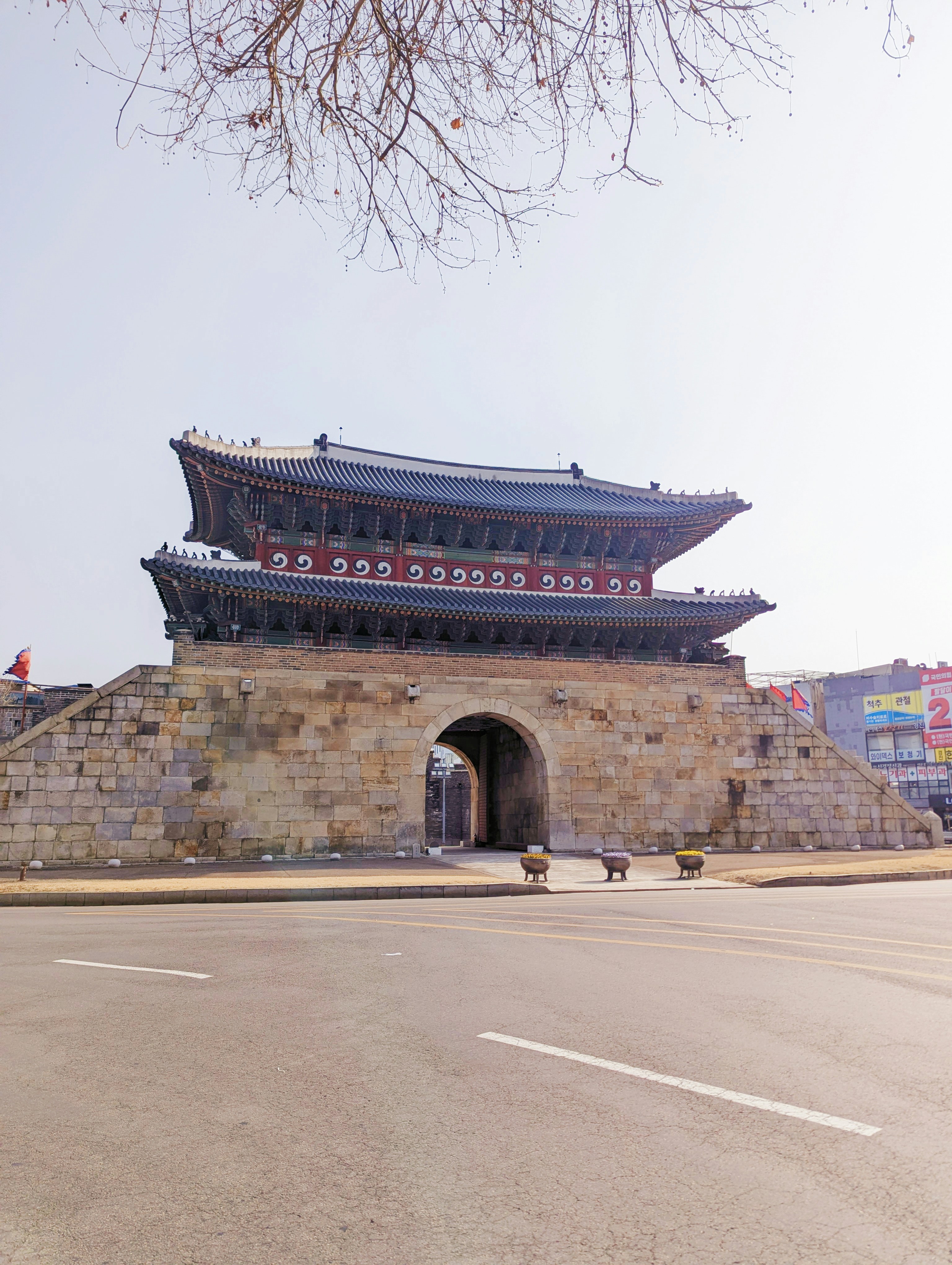 Historic korean gate with stone base and tiled roof