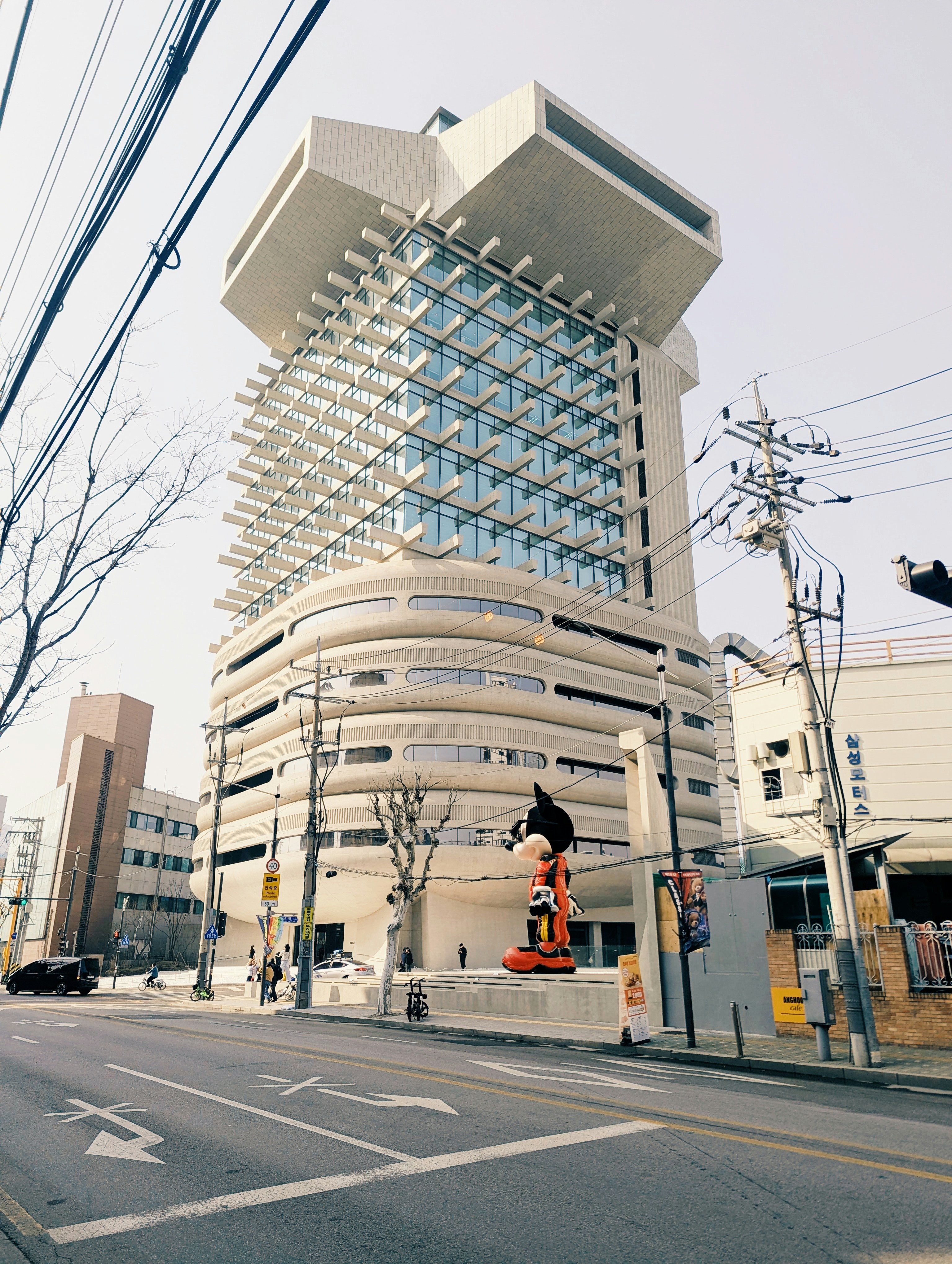 Modern building with a large cartoon character statue outside.