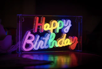 Rainbow neon sign says happy birthday