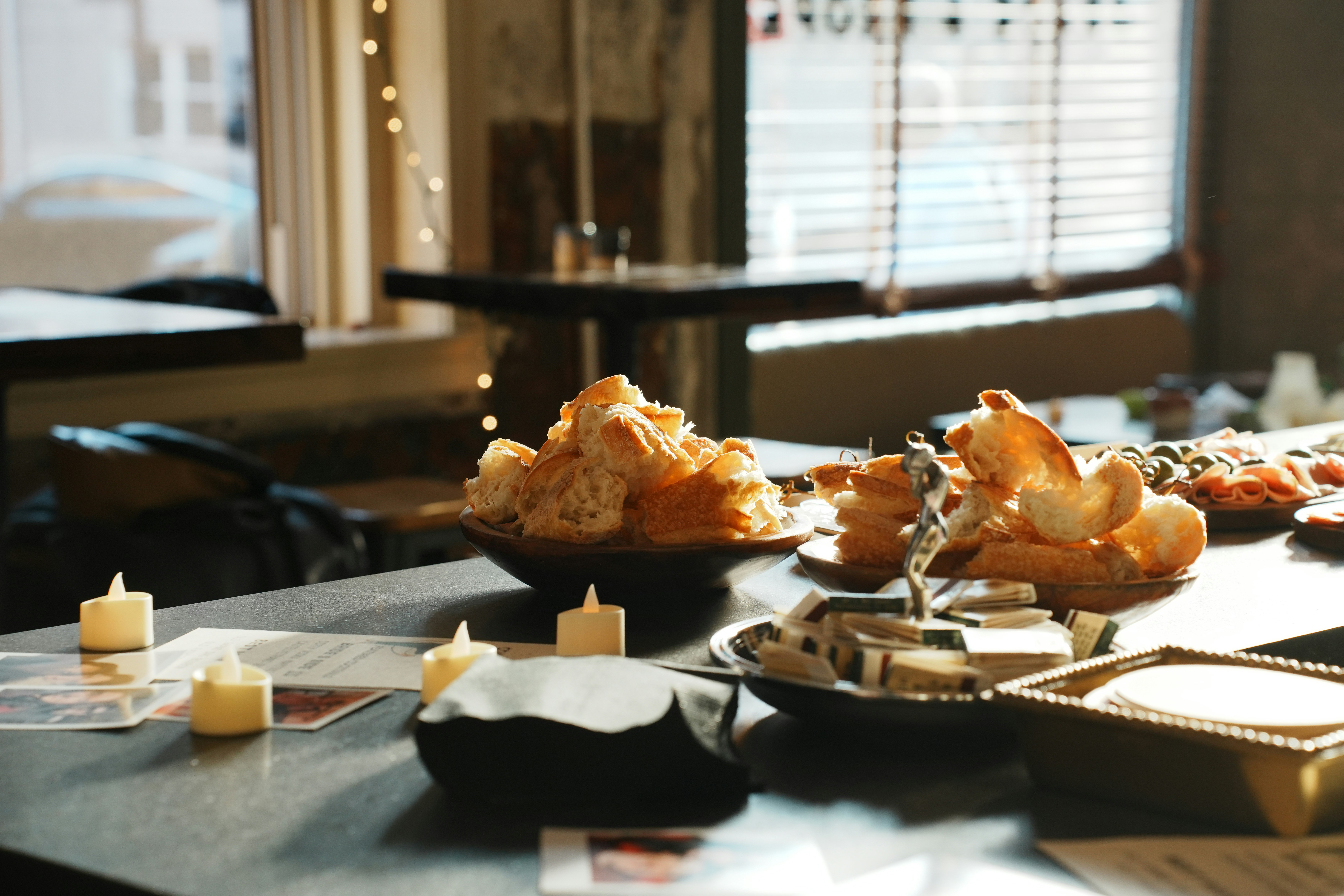 A table laden with pastries, candles, and decorative items.