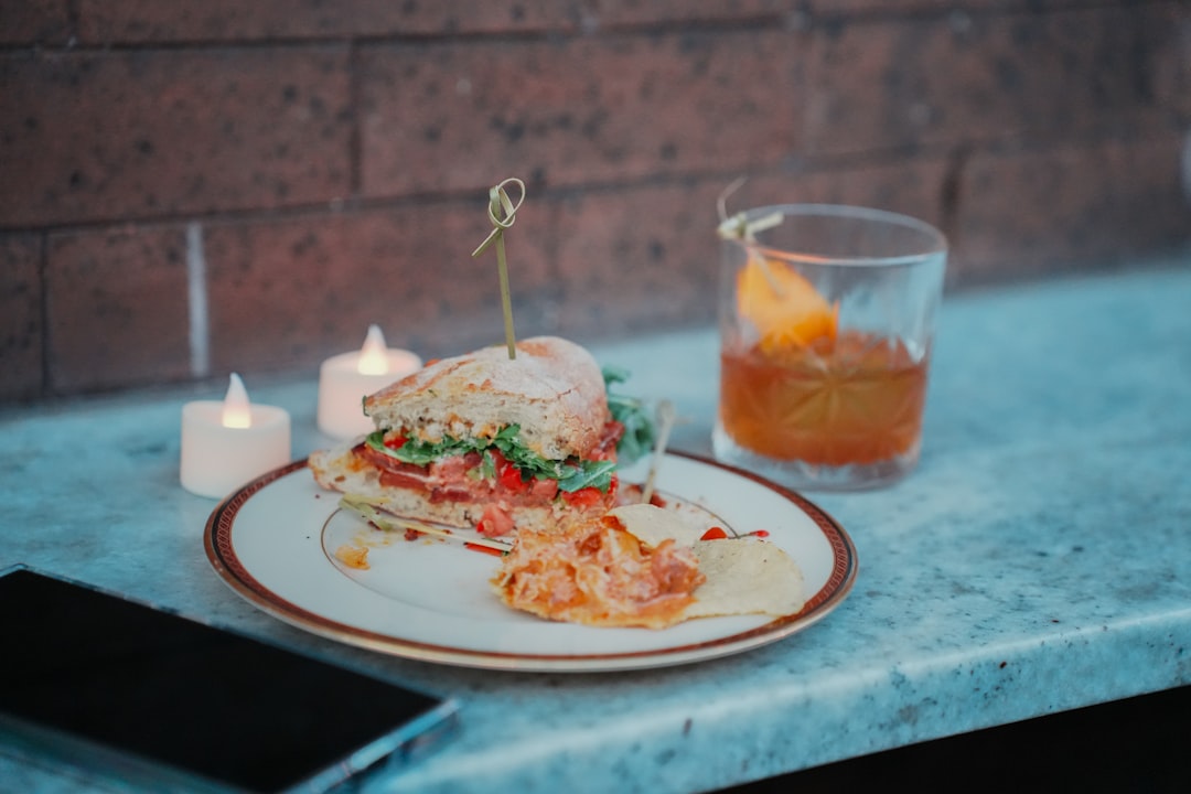 A sandwich with fries and a drink