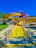 Bright yellow water slides at a sunny amusement park.
