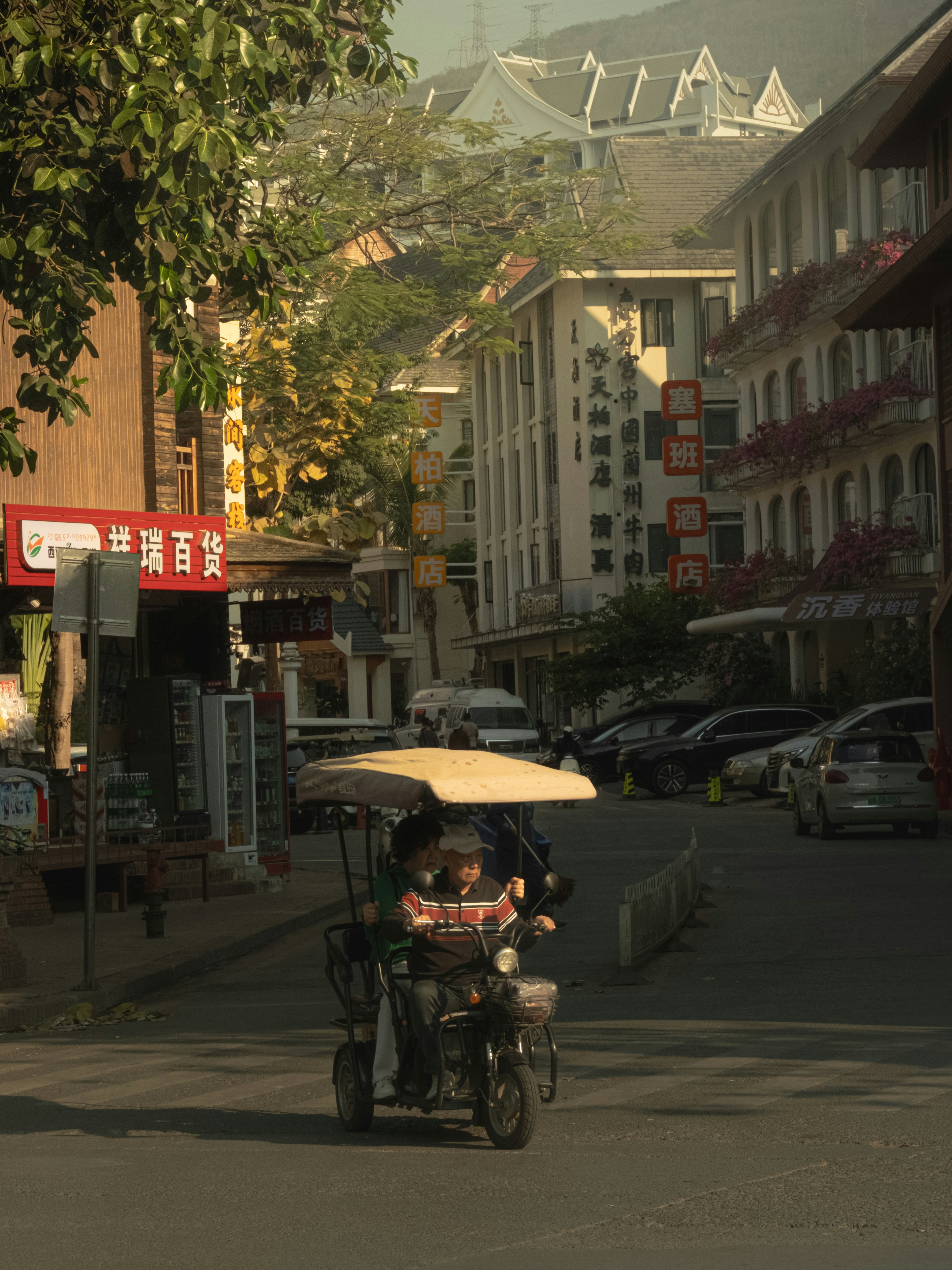 People ride an auto rickshaw down a street