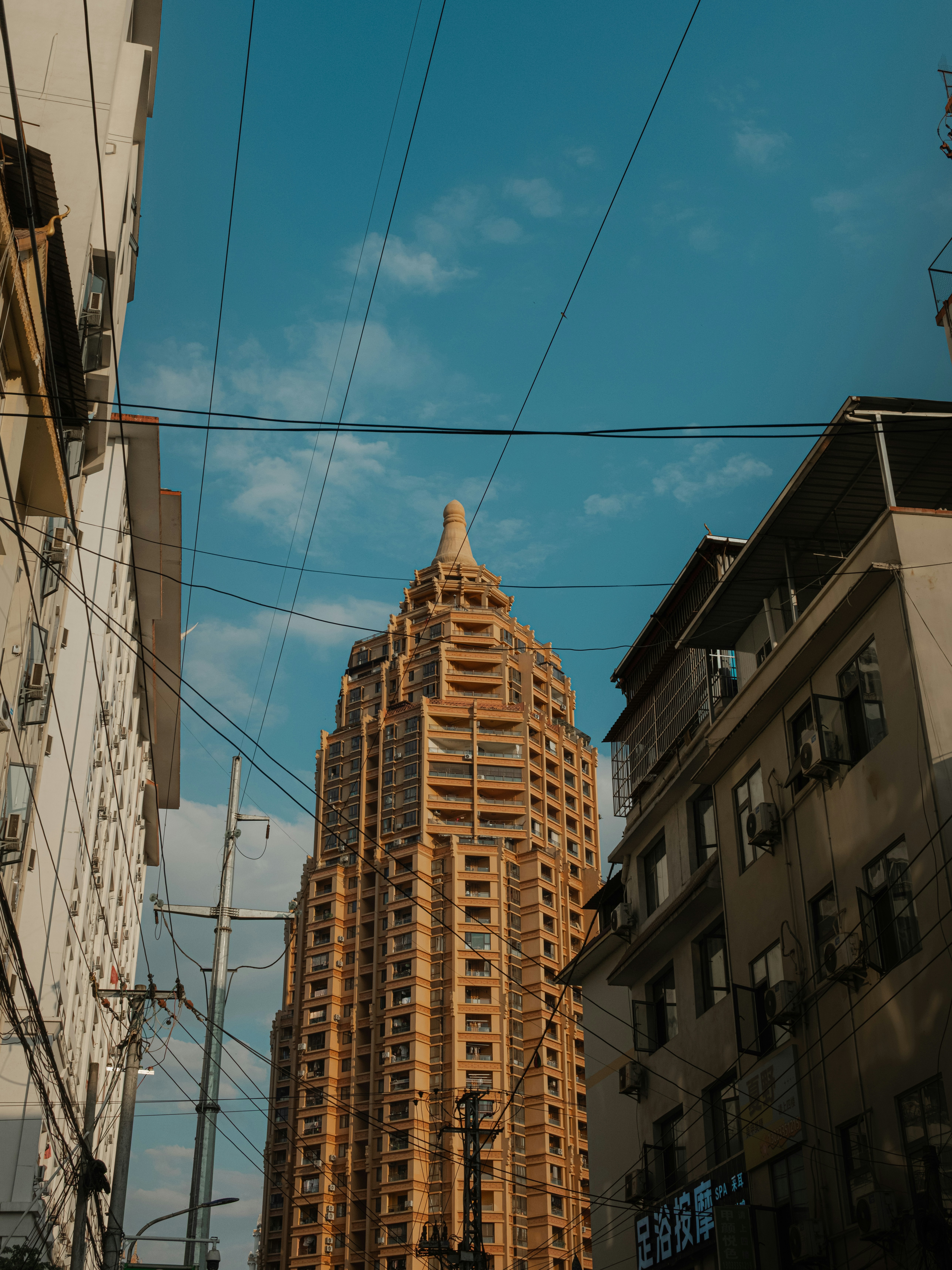 Tall, ornate building between city structures