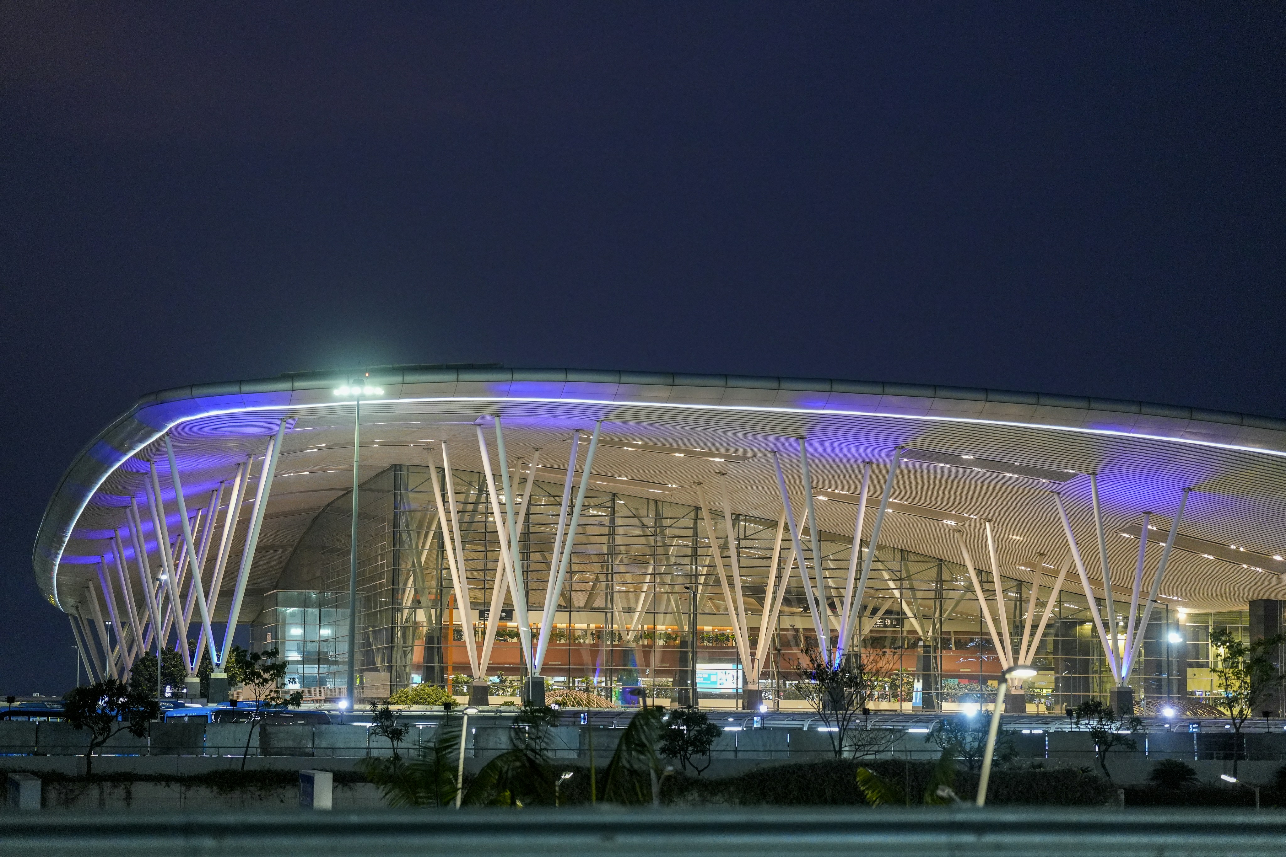 Modern building with illuminated roof at night.