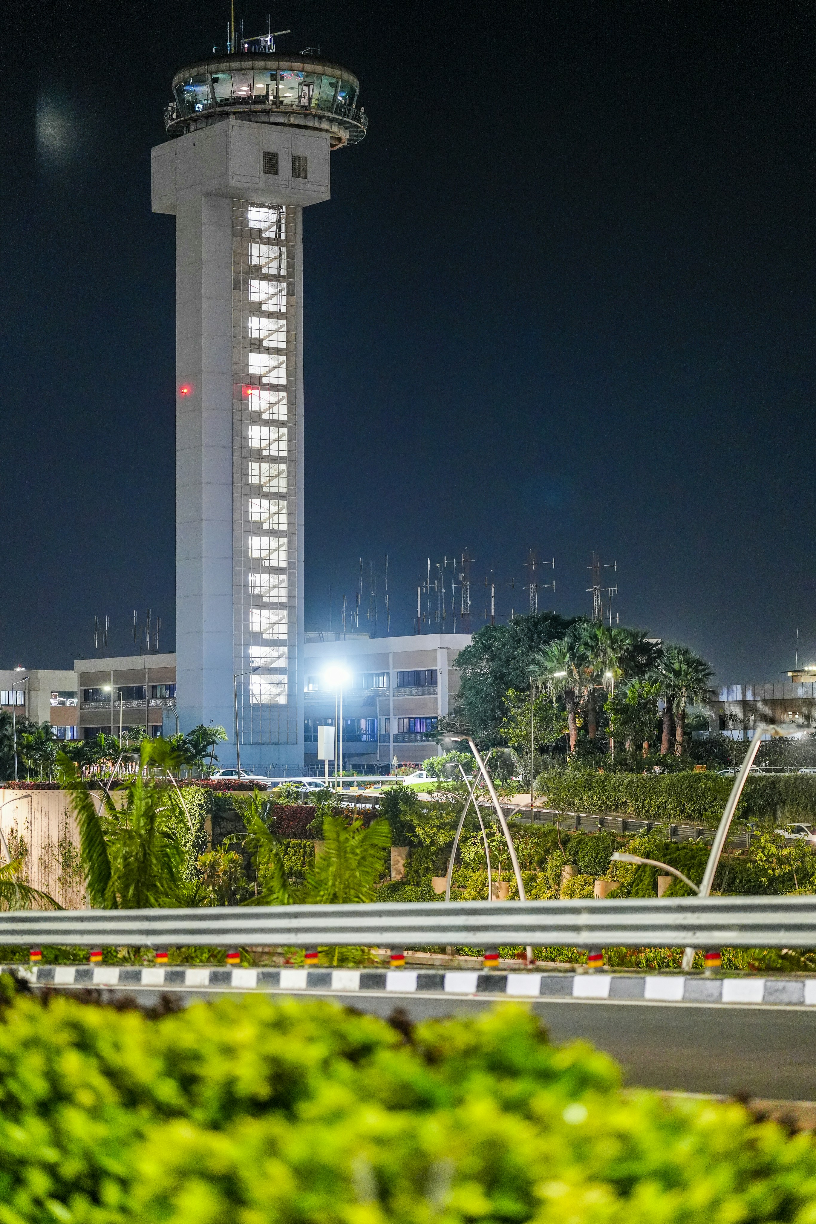 Airport control tower at night with illuminated windows