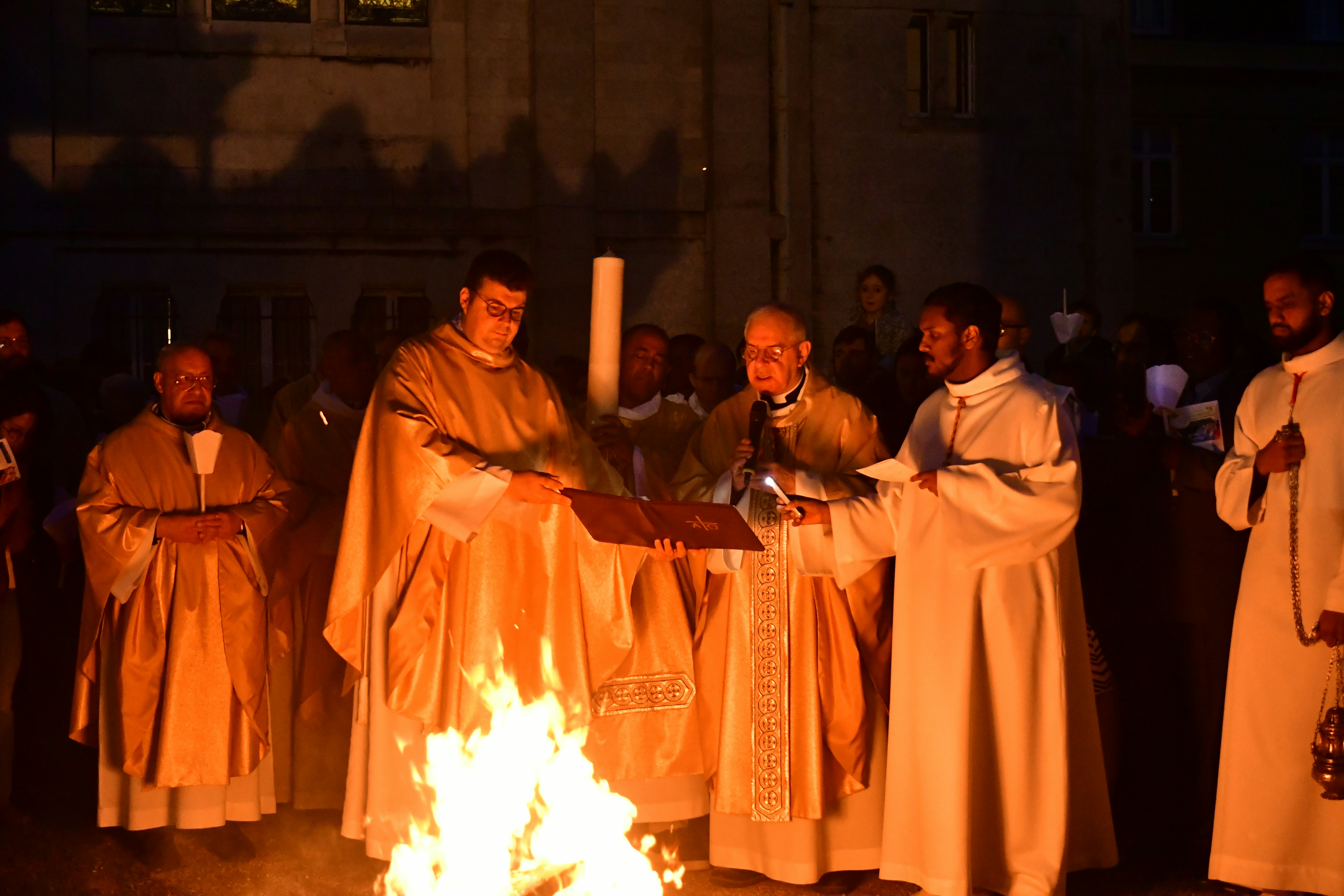 Clergy lighting a fire during a religious ceremony
