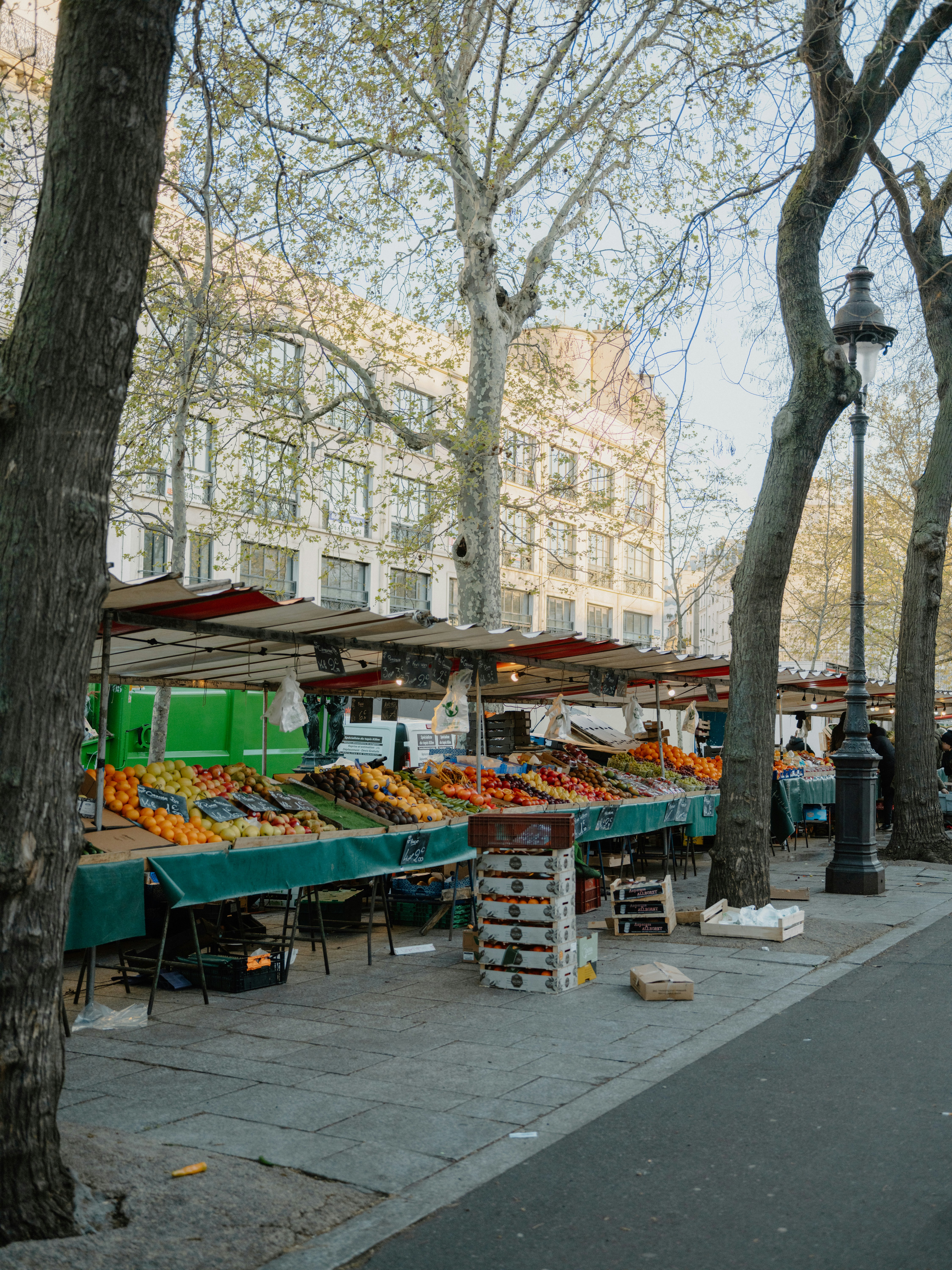 Outdoor market stalls filled with fresh fruits and vegetables