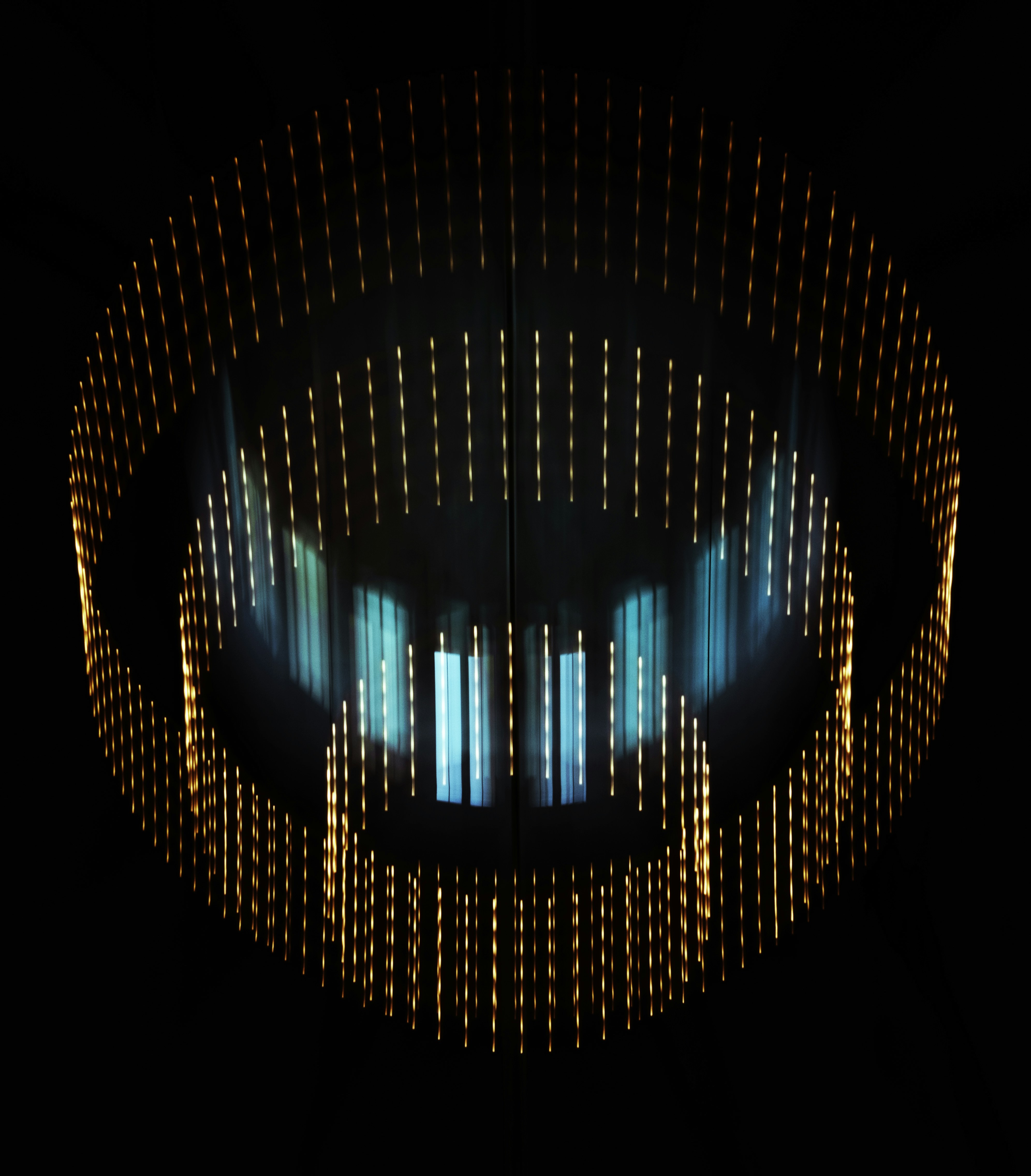 Circular light installation with glowing orange and blue elements