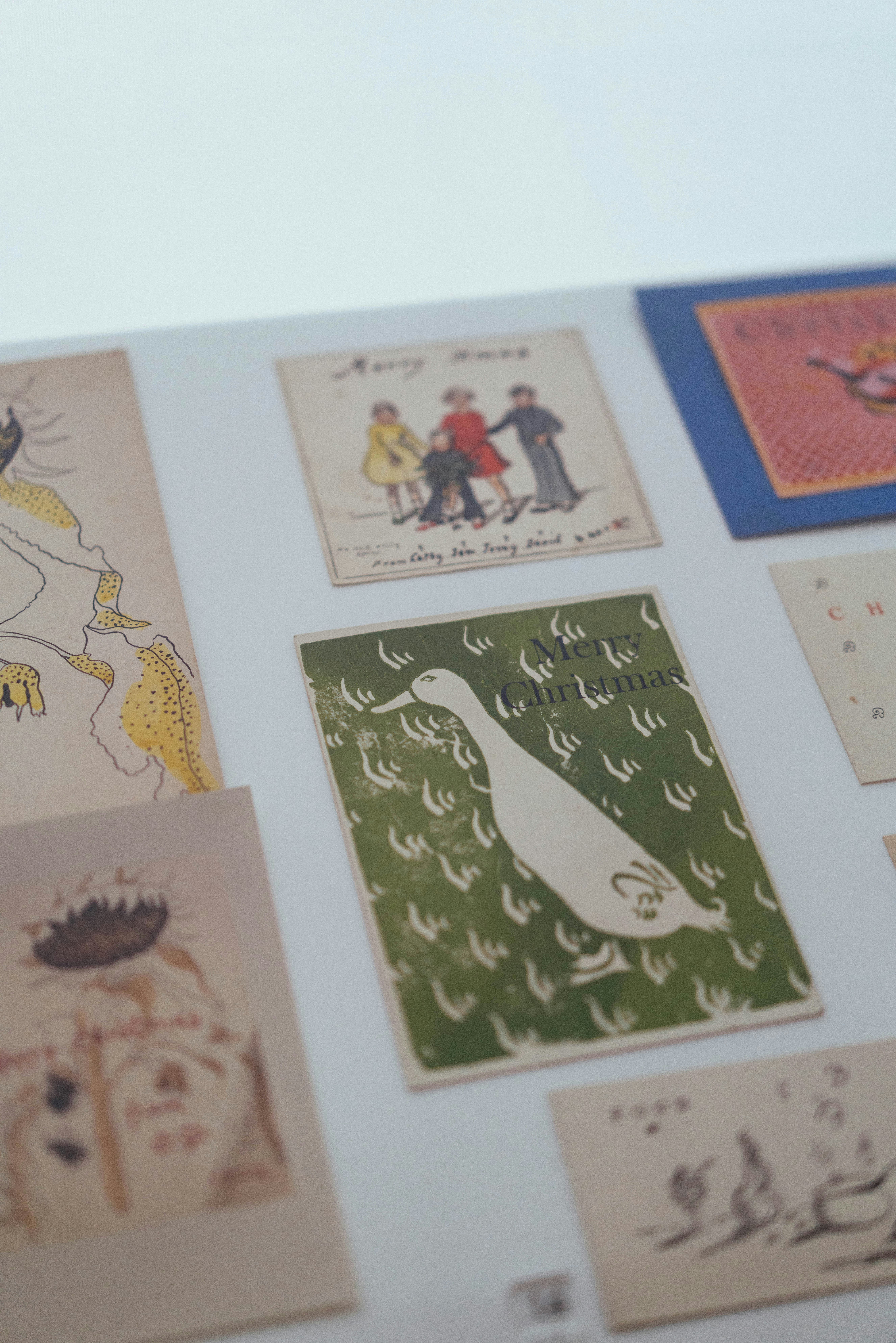 Collection of vintage illustrated cards with various designs.