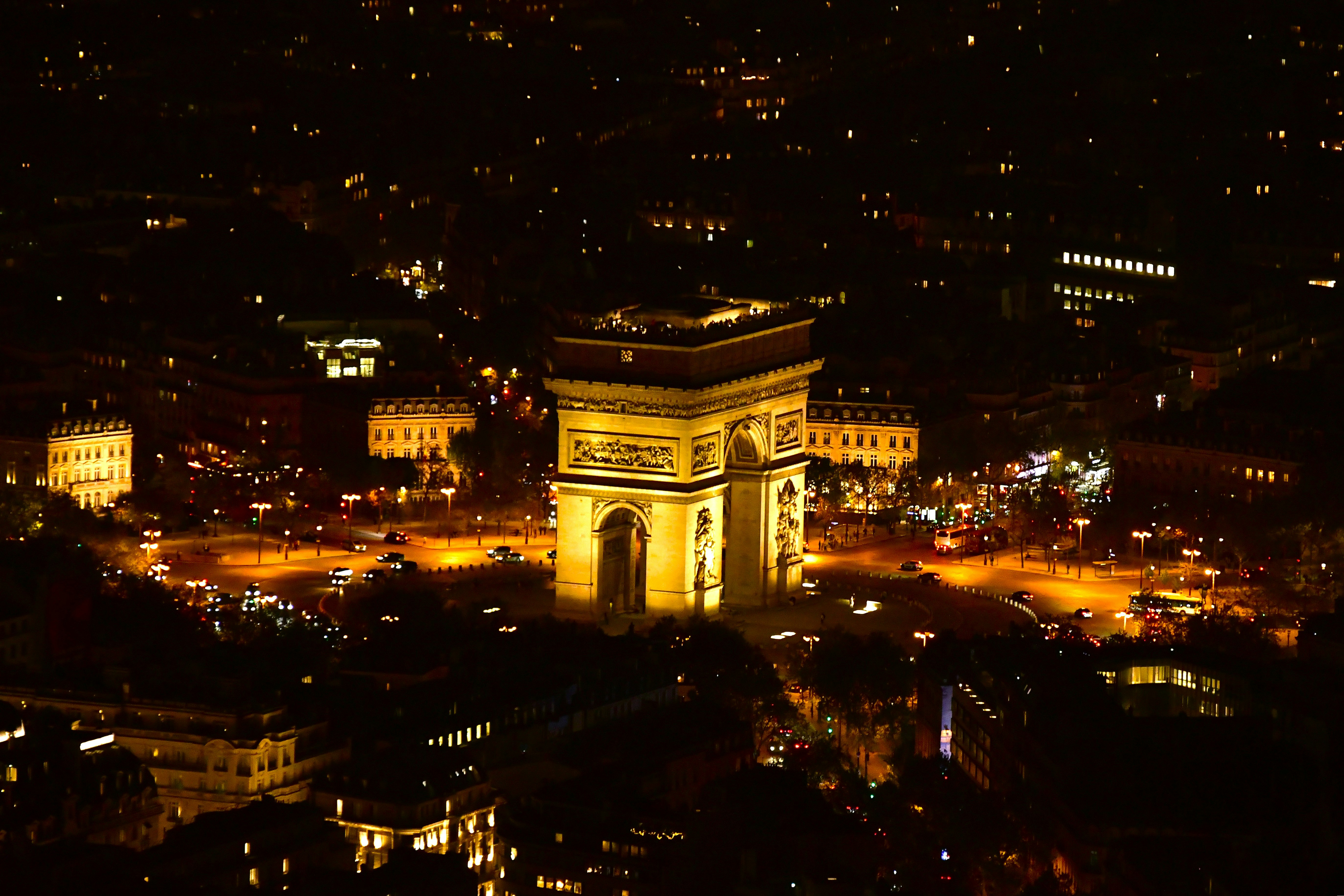 The arc de triomphe illuminated at night in paris.