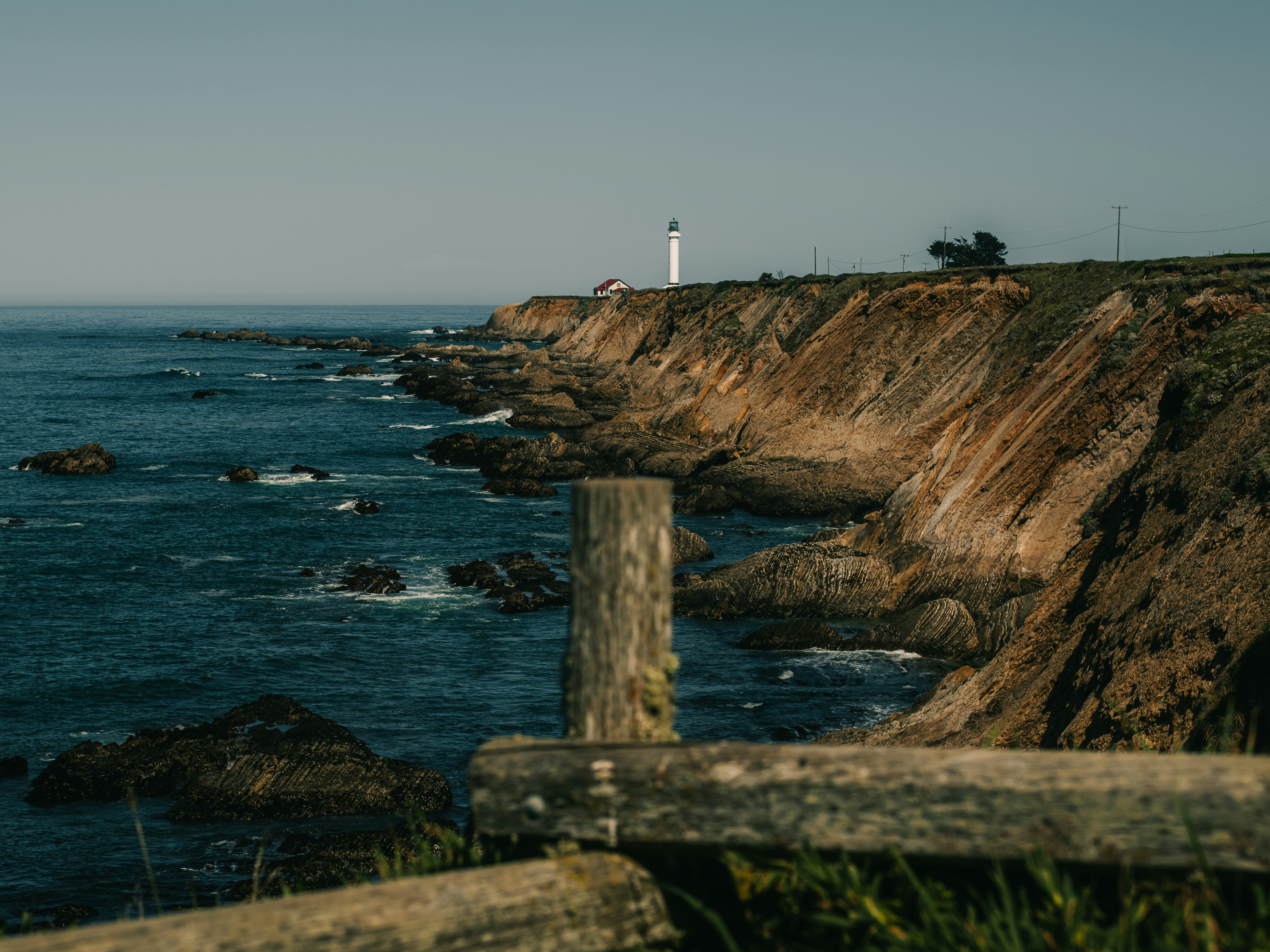 Lighthouse on a rocky coastline overlooking the ocean