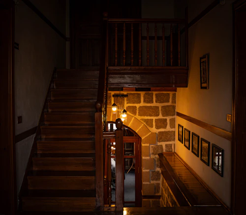 Wooden staircase and stone wall