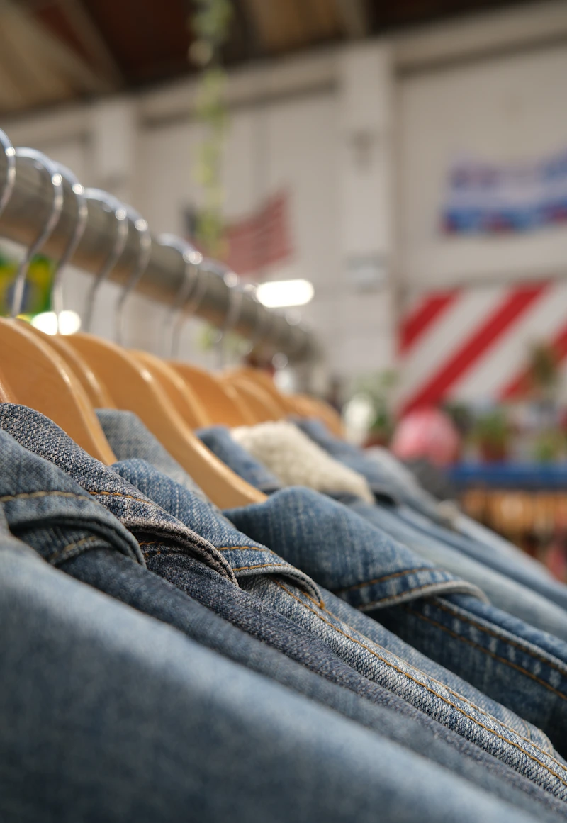 Denim jackets hanging on a store rack