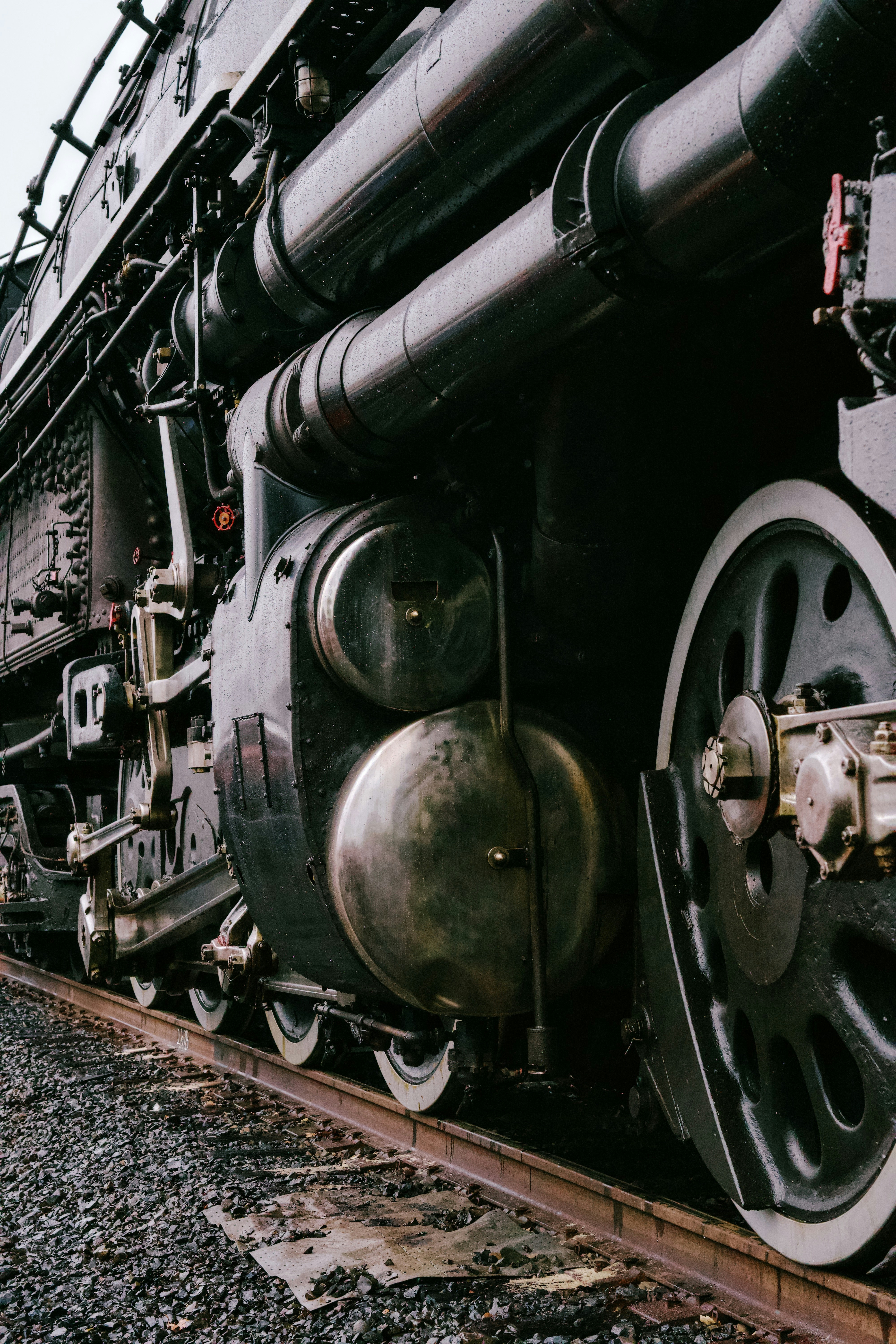 Close-up of a vintage steam locomotive on tracks.