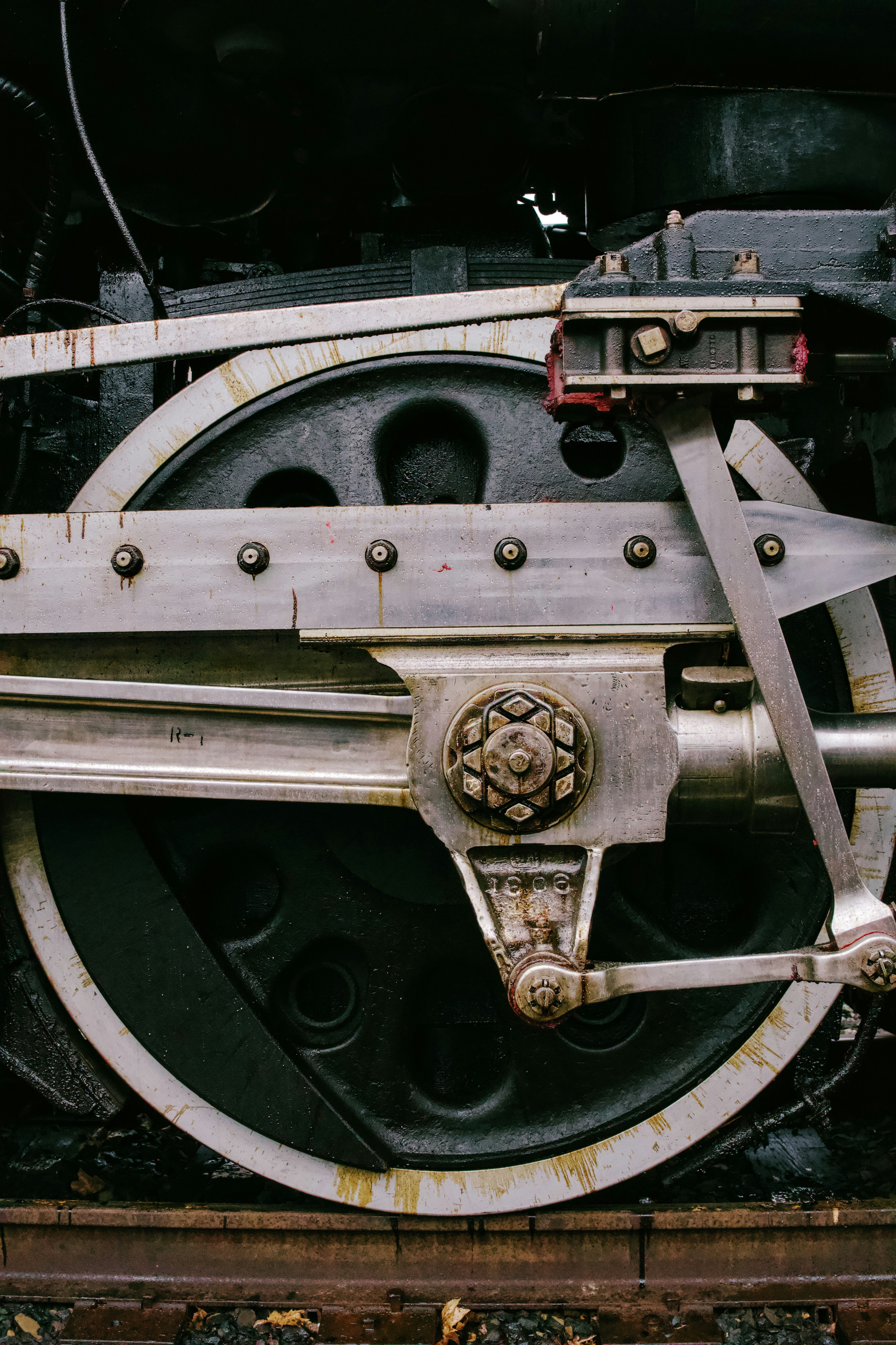 Close-up of a vintage steam train wheel mechanism.
