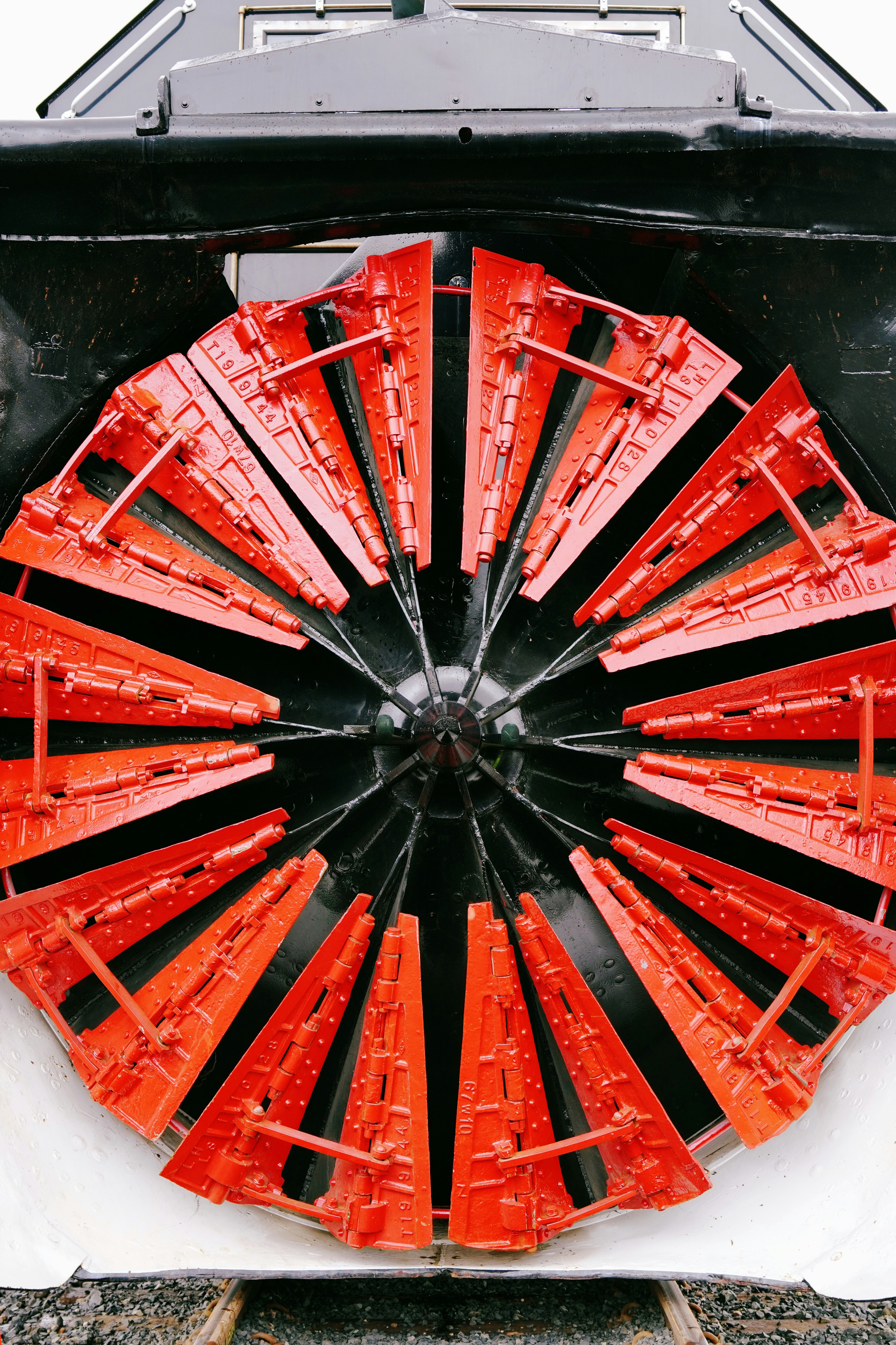 Front view of a red and black snowplow
